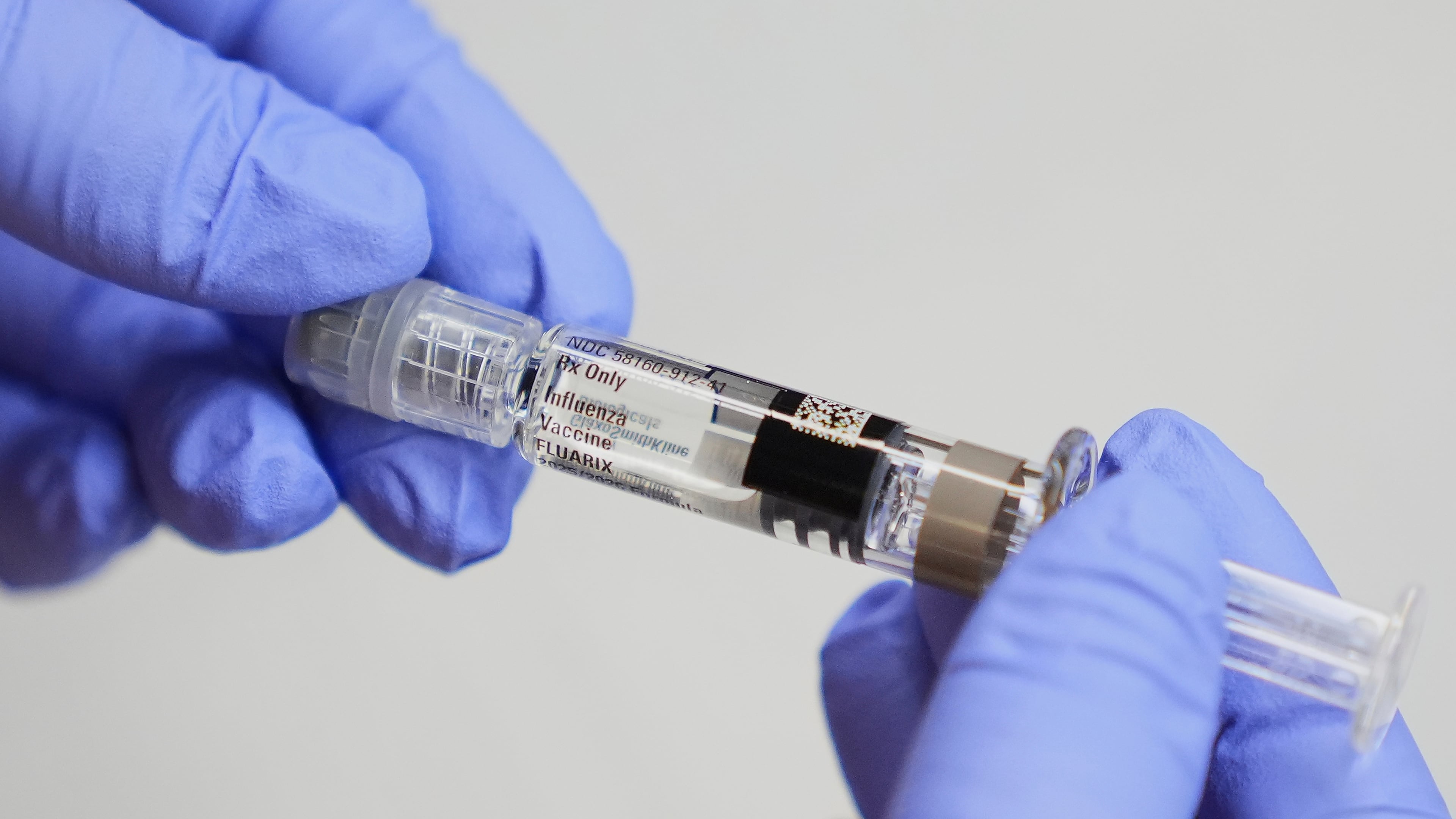 FILE - A certified medical assistant holds a syringe for a flu vaccine at a clinic in Seattle, on Sept. 10, 2025. (AP Photo/Lindsey Wasson, File)