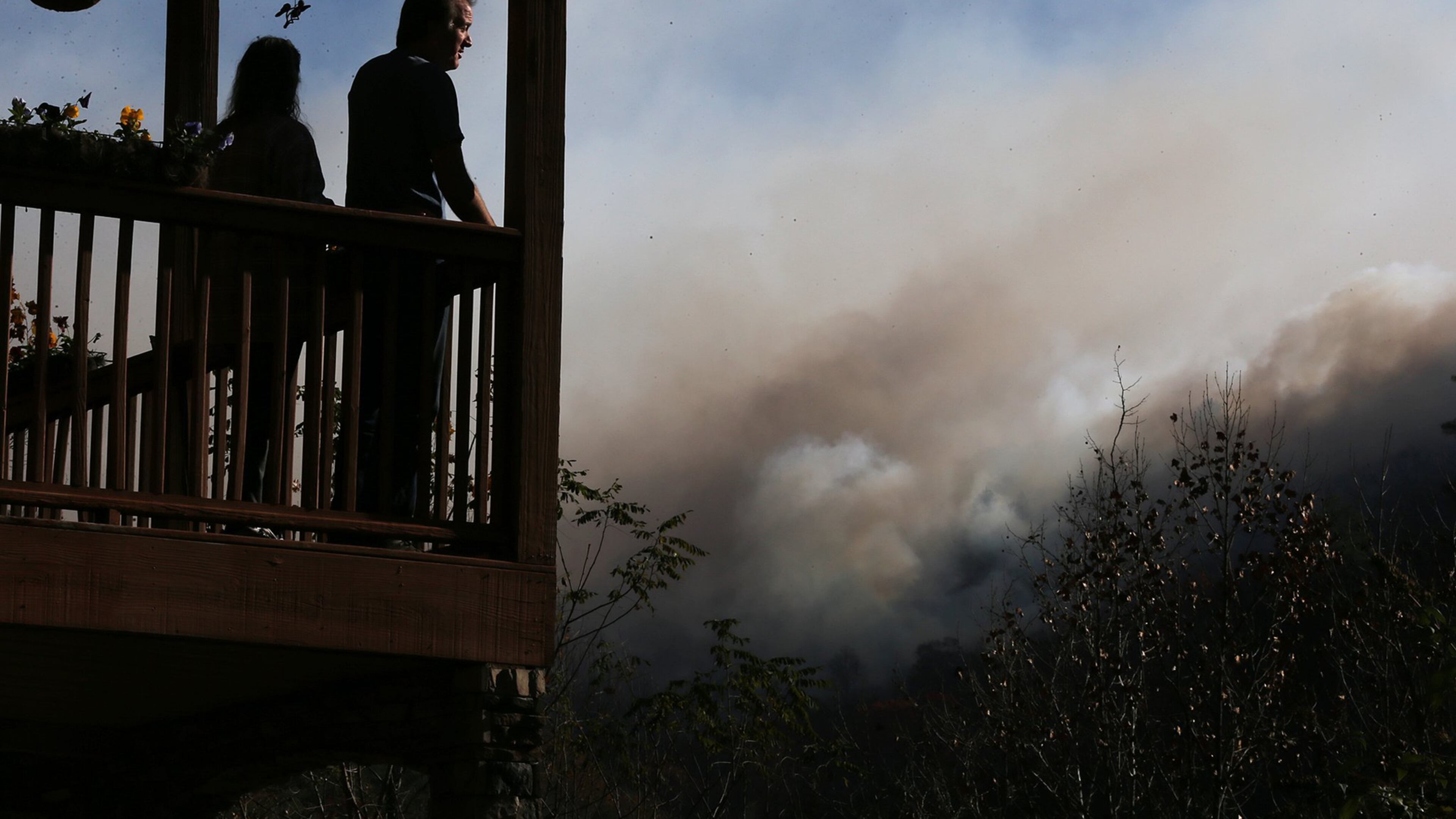 November 16, 2016, Tate City: Eric and Vebbra Willey watch from their porch as the Rock Mountain Fire approaches closer to their home on Wednesday, Nov. 16, 2016, in Tate City. Residents are under a pre-evacuation order as firefighters work to keep the fire away from homes. Curtis Compton/ccompton@ajc.com