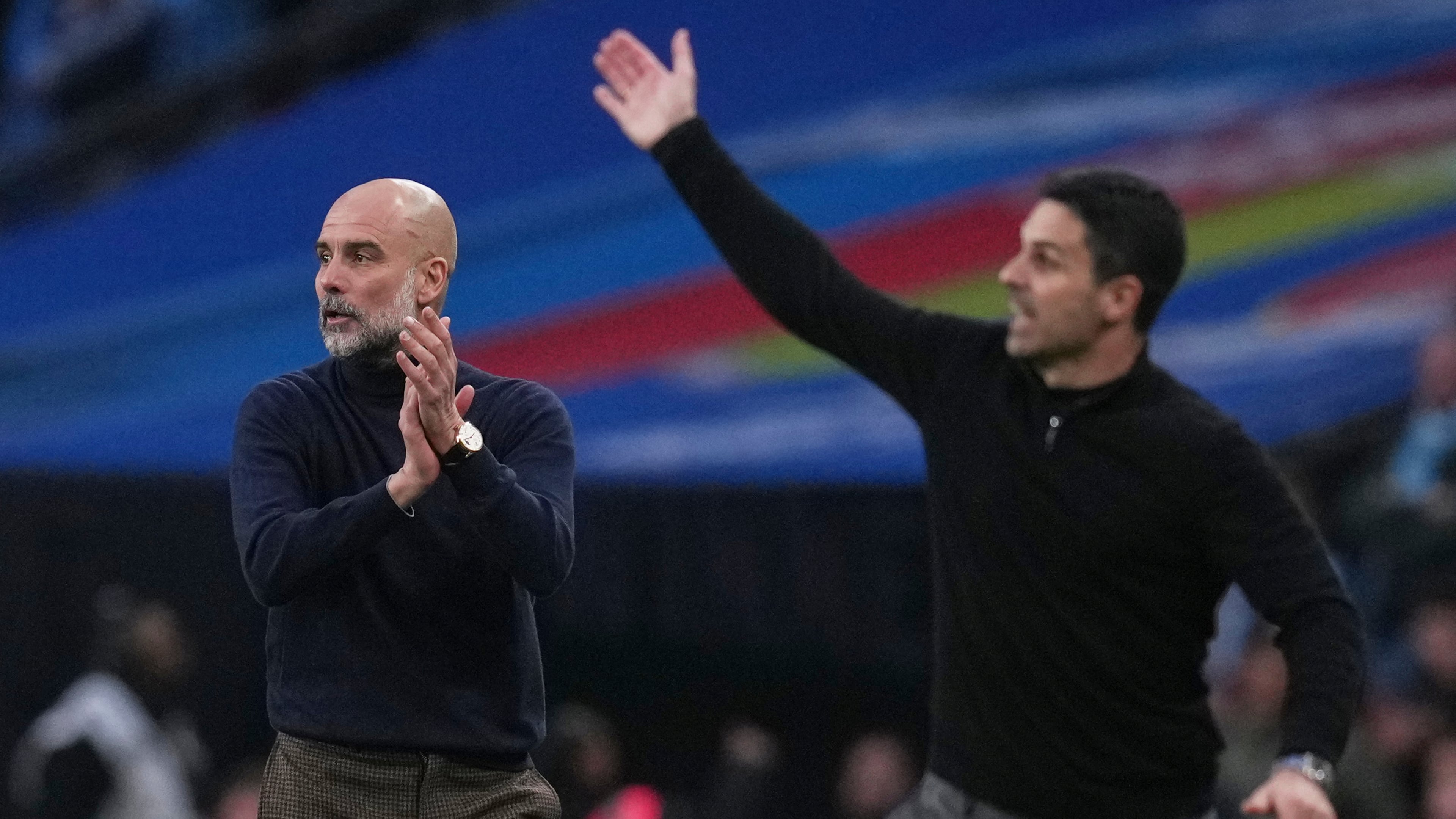 Manchester City's head coach Pep Guardiola, left encourages his players as Arsenal's manager Mikel Arteta gestures to his during the English League Cup final soccer match between Arsenal and Manchester City in London, Sunday, March 22, 2026. (AP Photo/Maja Smiejkowska)