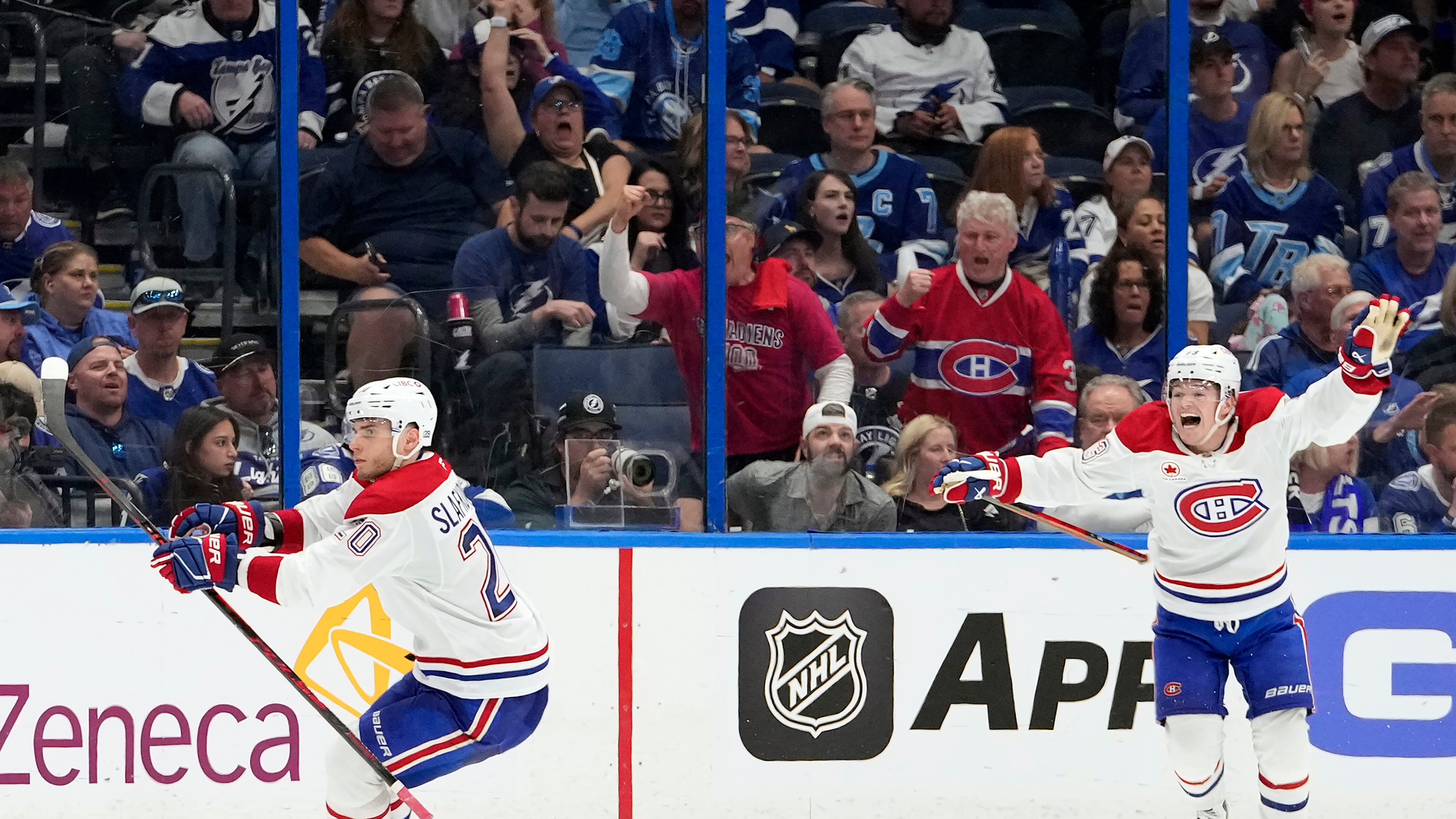 Montréal Canadiens left wing Juraj Slafkovský (20) celebrates his goal with right wing Cole Caufield against the Tampa Bay Lightning during overtime in Game 1 of an NHL hockey Stanley Cup first-round playoff series, Sunday, April 19, 2026, in Tampa, Fla. (AP Photo/Chris O'Meara)