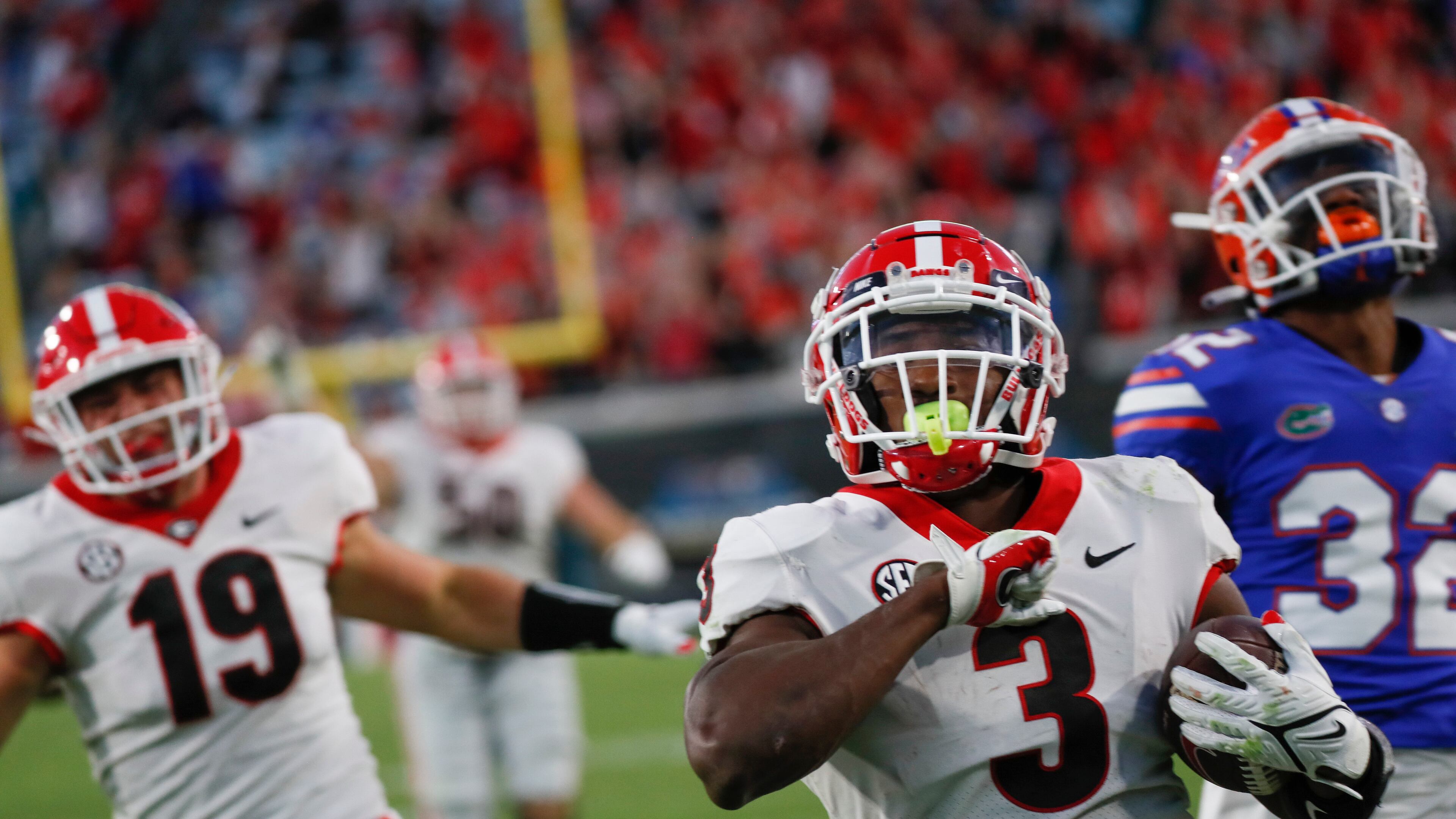 Georgia Bulldogs running back Zamir White (3) scores on this fourth-quarter touchdown run during the second half of the annual Georgia vs Florida game at TIAA Bank Field in Jacksonville. Georgia won 34-7. Bob Andres / bandres@ajc.com