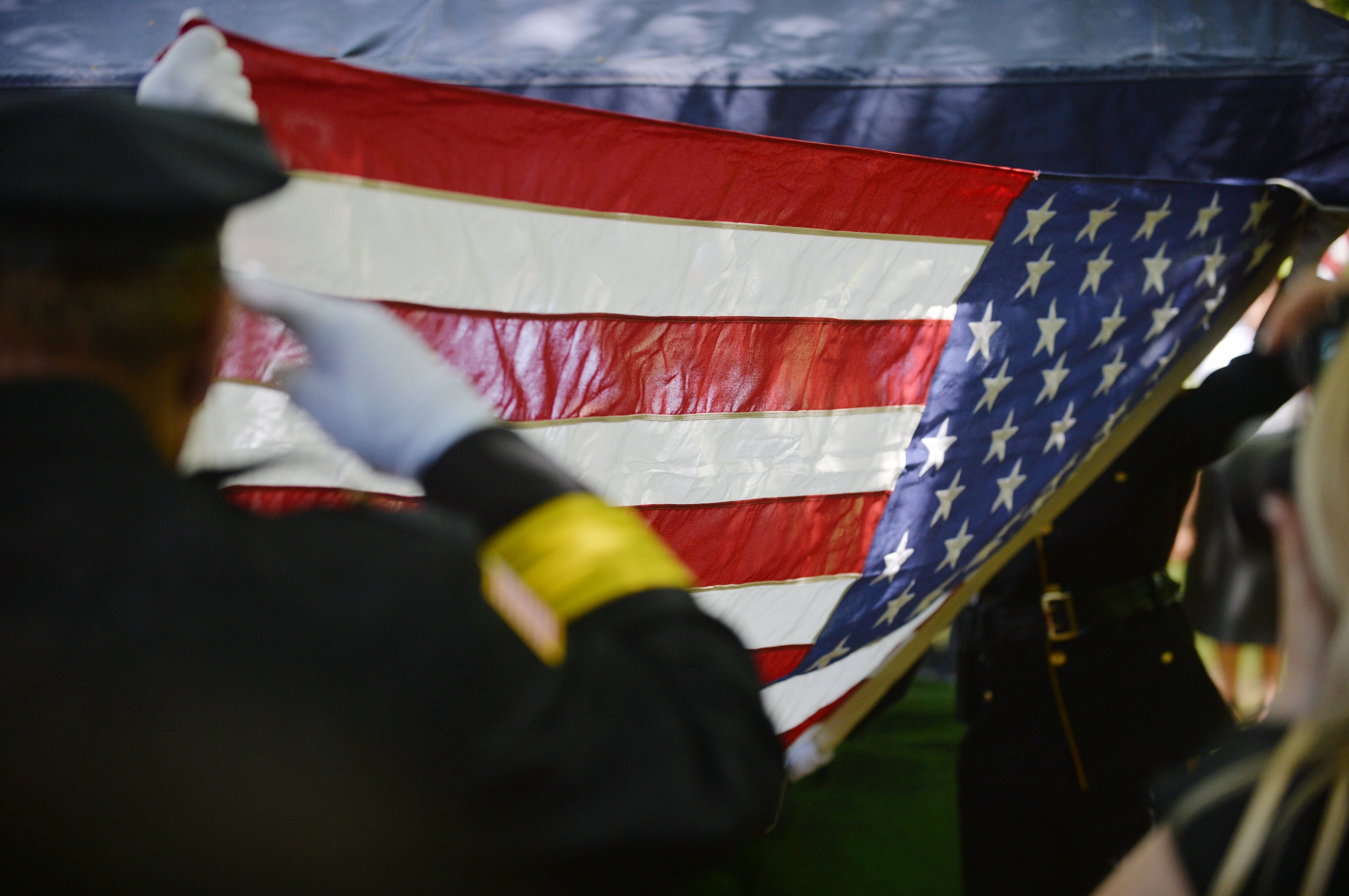 Honor Guard members fold the flag for presentation to Hawk family. CPR was performed on the officer shortly after he collapsed, but he was not able to be revived.