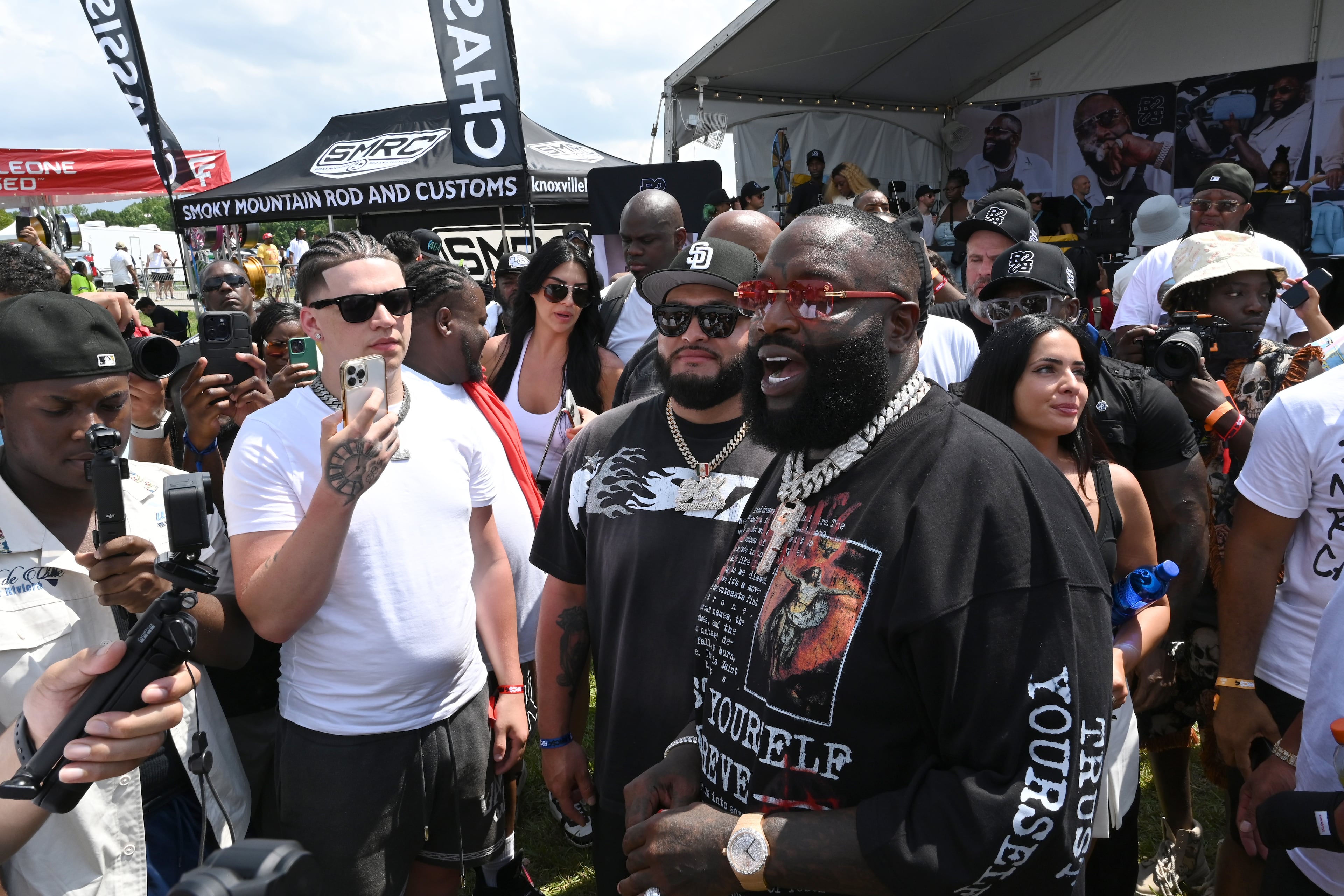 Rick Ross meets and greets attendees and vendors during the 4th Annual Rick Ross Car and Bike Show, Saturday, June 7, 2025, in Fayetteville. The 4th Annual Rick Ross Car and Bike Show will include a vendor market with more than 30 vendors, food trucks, fleets of classic/custom automobiles, luxury vehicles, boats, RVs and trailers on the front of the mansion. Stage performances include Plies, Ross' new signee Nino Breeze and Ross himself. (Hyosub Shin / AJC)