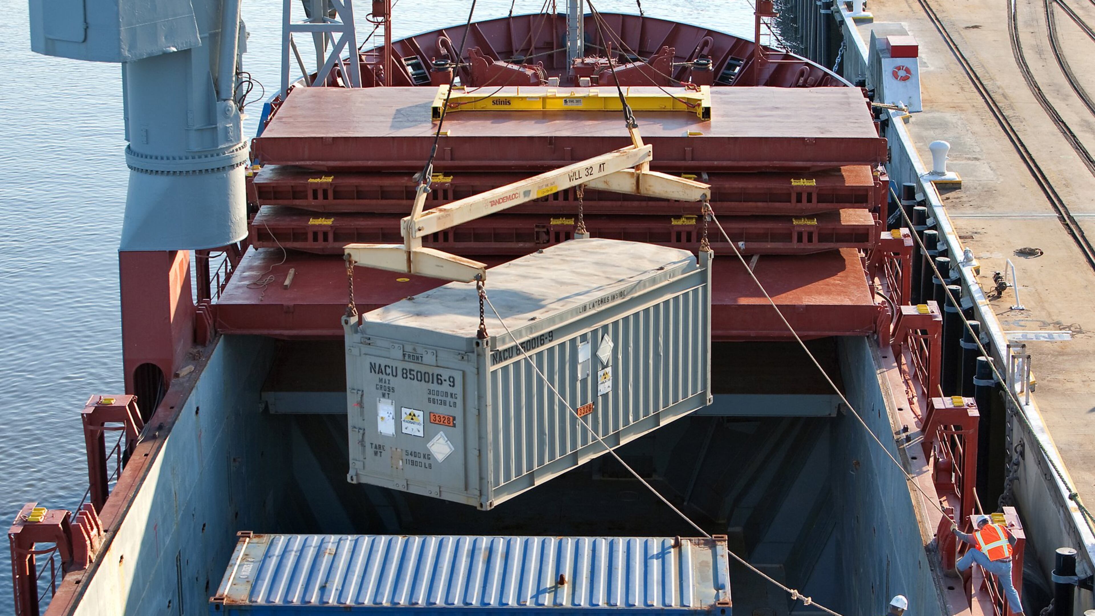 A massive crane gingerly lifts a container of highly-enriched uranium from the cargo hold of a ship arriving at the Charleston Weapons Station near Goose Creek, S.C., from Chile. The container was bound for the Savannah River Site. (AP Photo/Mic Smith)