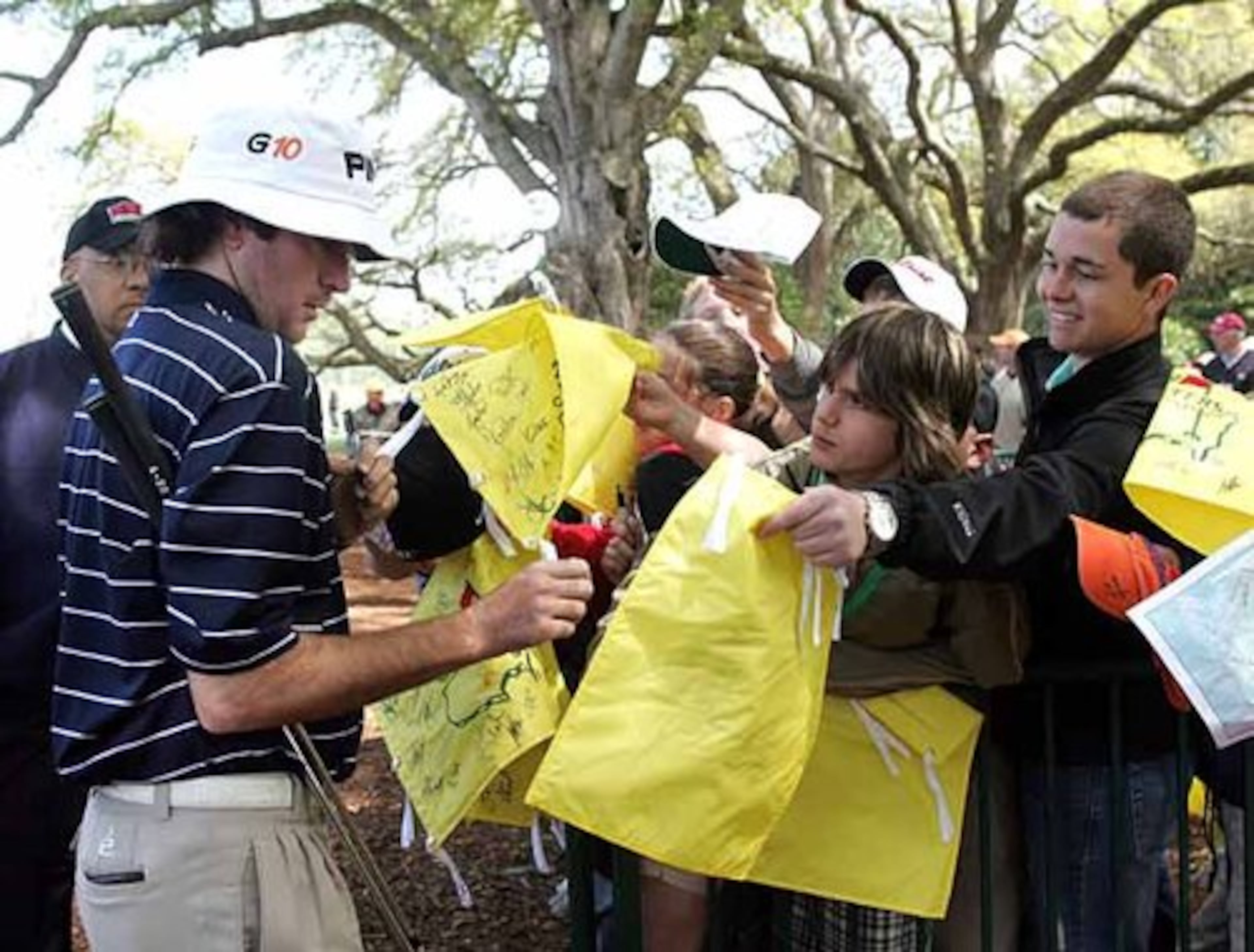 Bubba Watson signs autographs while leaving the practice tee.