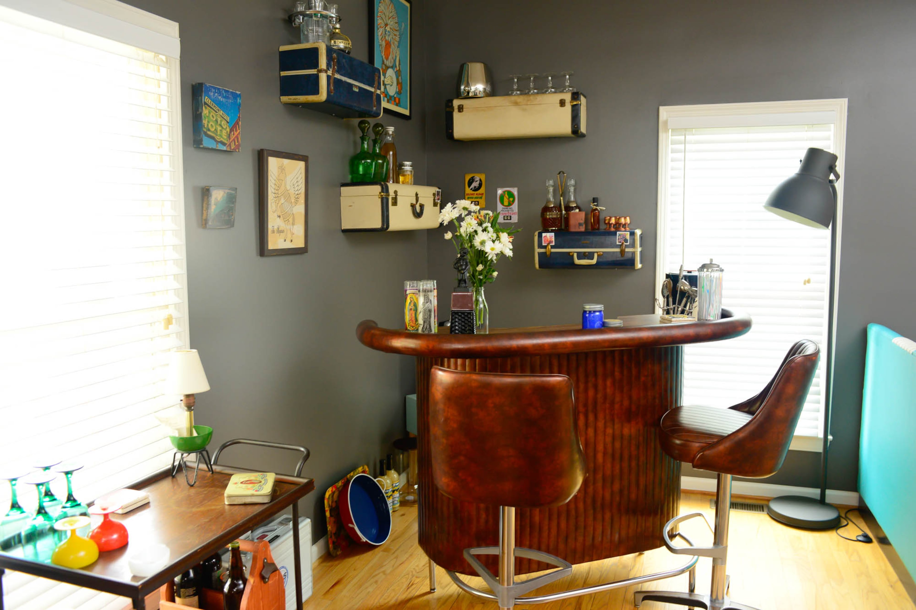 With a vintage bar and portable cart, the couple set up their open living area to make entertaining easy.
