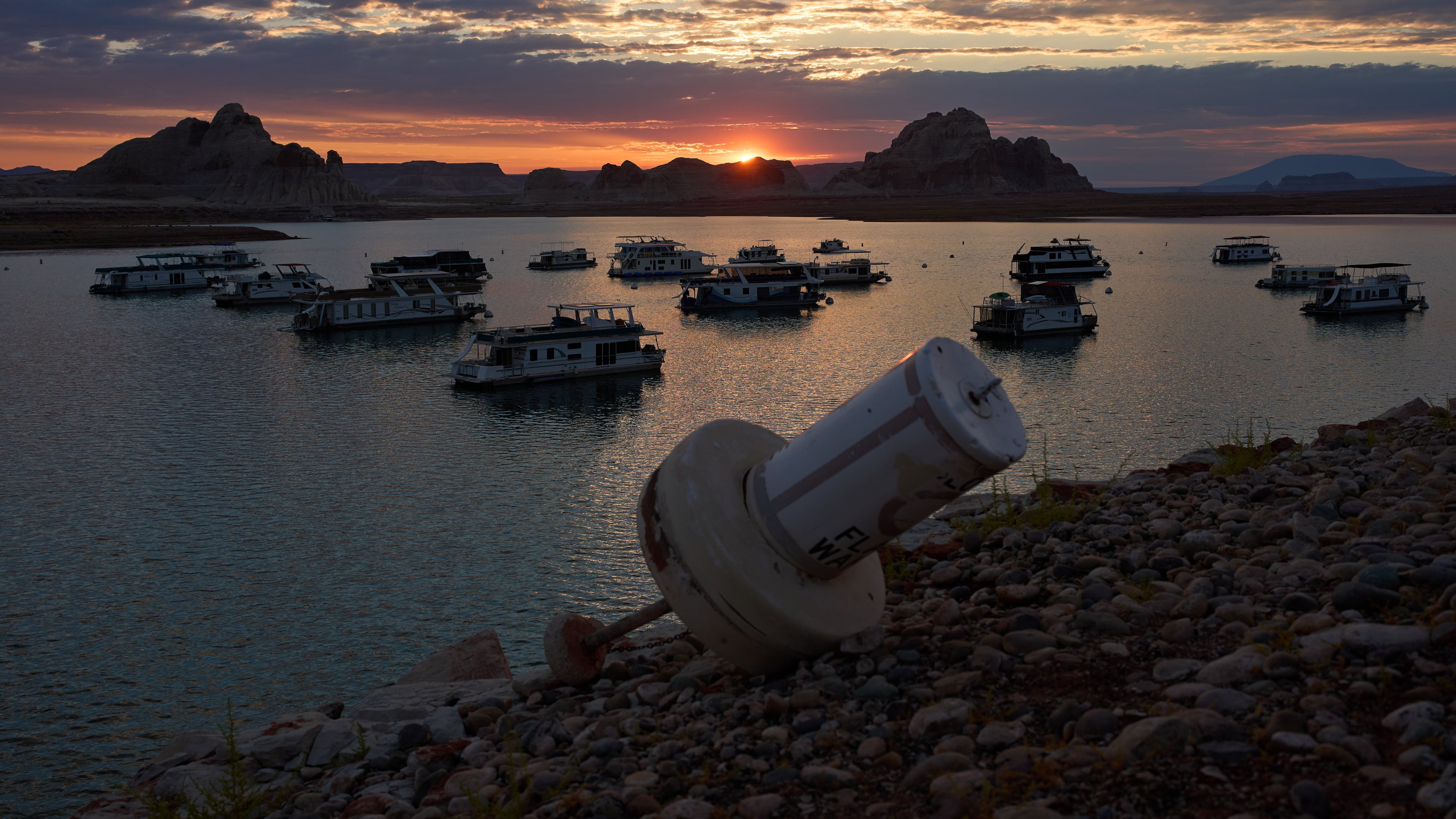 FILE - A formerly floating buoy now sits high and dry above Lake Powell at the Glen Canyon National Recreation Area, July 15, 2026, near Page, Nev. (AP Photo/John Locher, File)