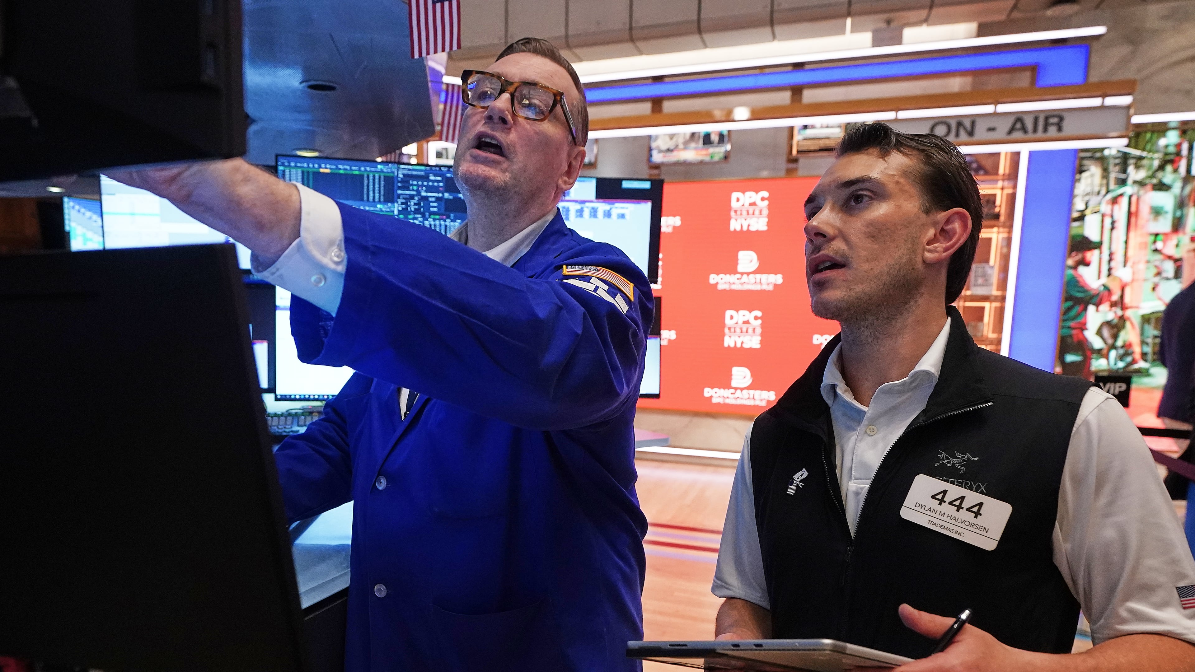 Specialist Patrick King, left, and trader Dylan Halvorsen work on the floor of the New York Stock Exchange, Thursday, June 25, 2026. (AP Photo/Richard Drew)