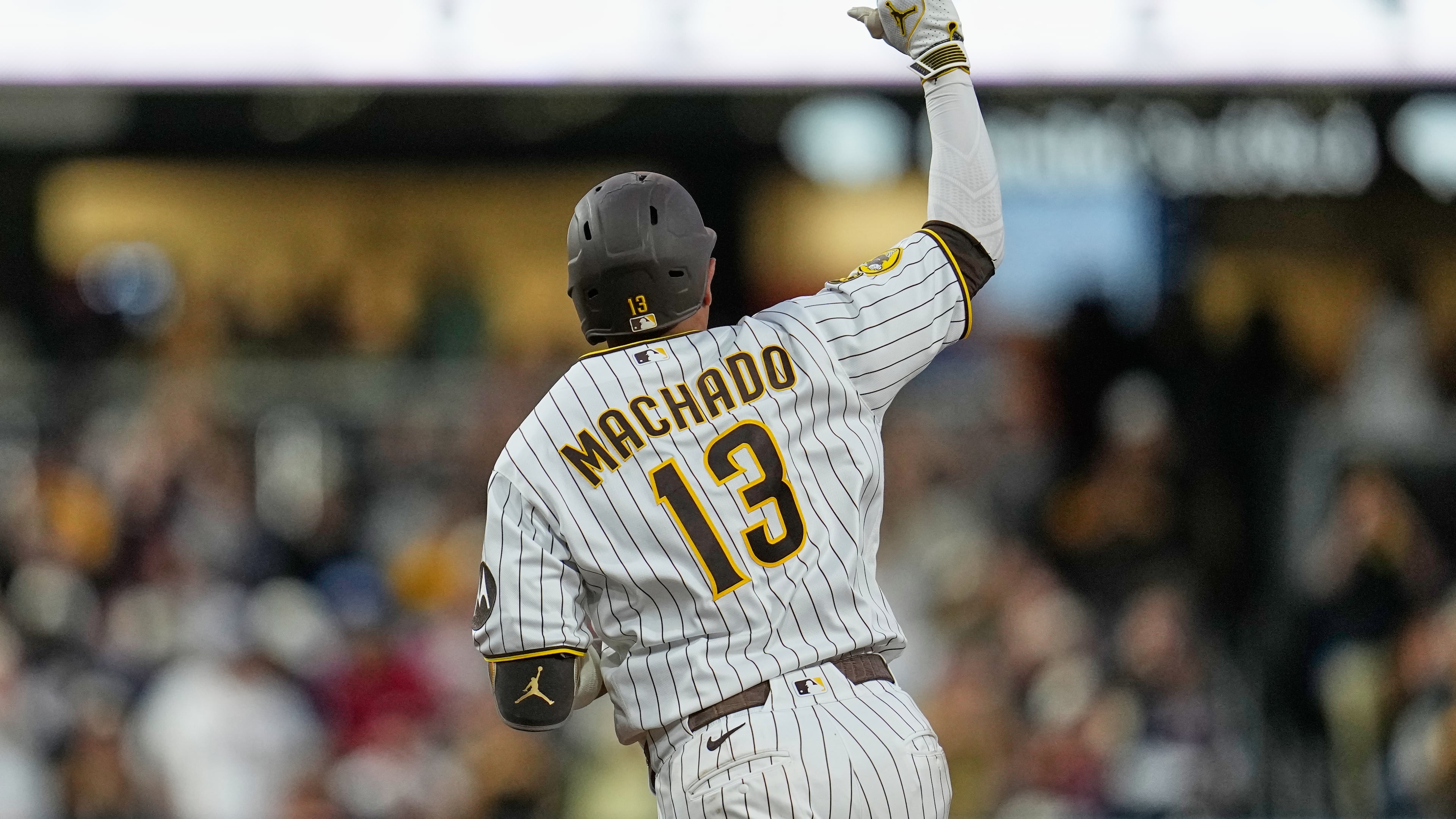 San Diego Padres' Manny Machado celebrates after hitting a home run during the fourth inning of a baseball game against the Atlanta Braves Monday, June 22, 2026, in San Diego. (AP Photo/Gregory Bull)