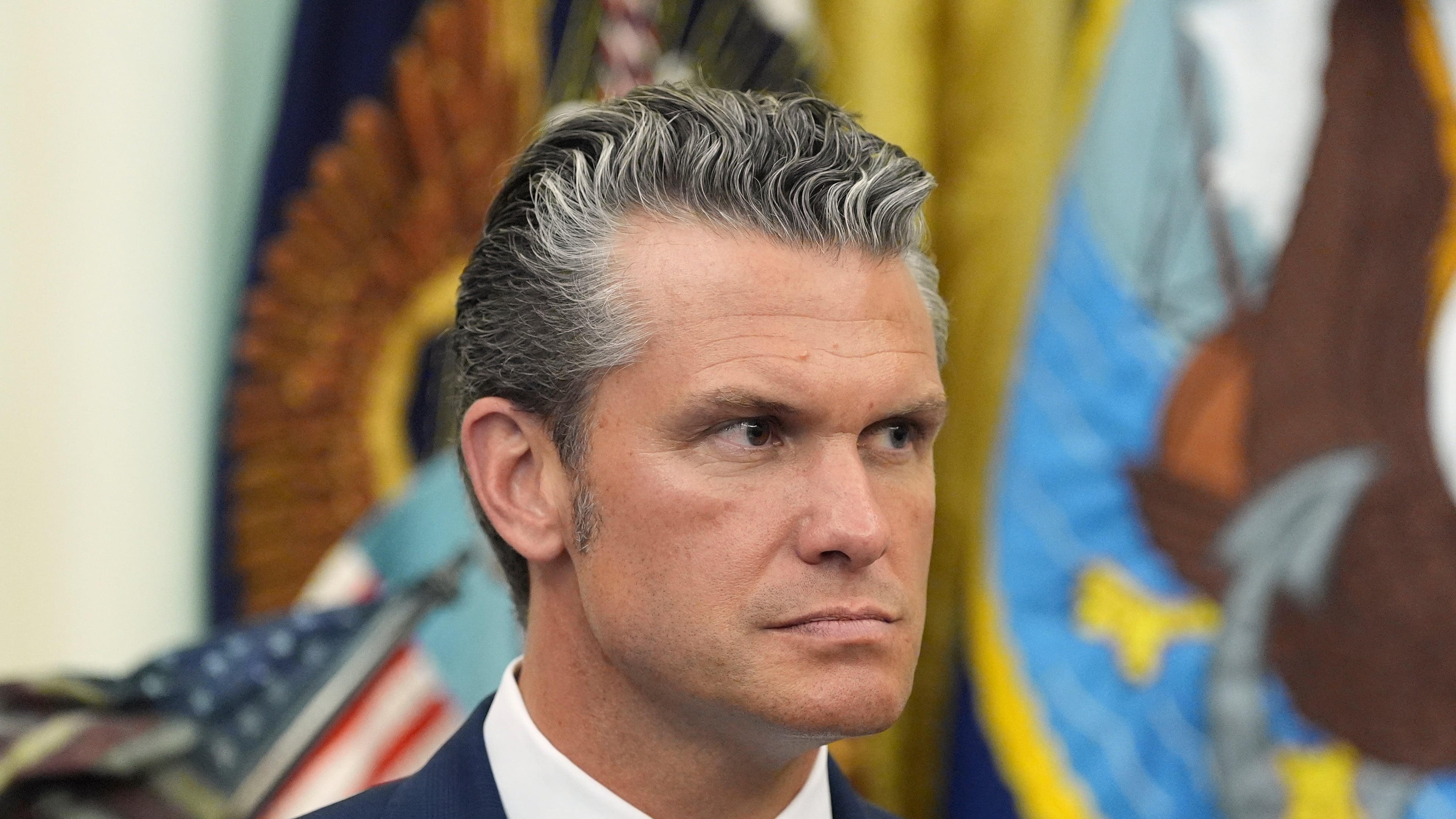 Defense Secretary Pete Hegseth listens as President Donald Trump speaks during a meeting about military families, in the Oval Office of the White House, Monday, Aug. 3, 2026, in Washington. (AP Photo/Alex Brandon)