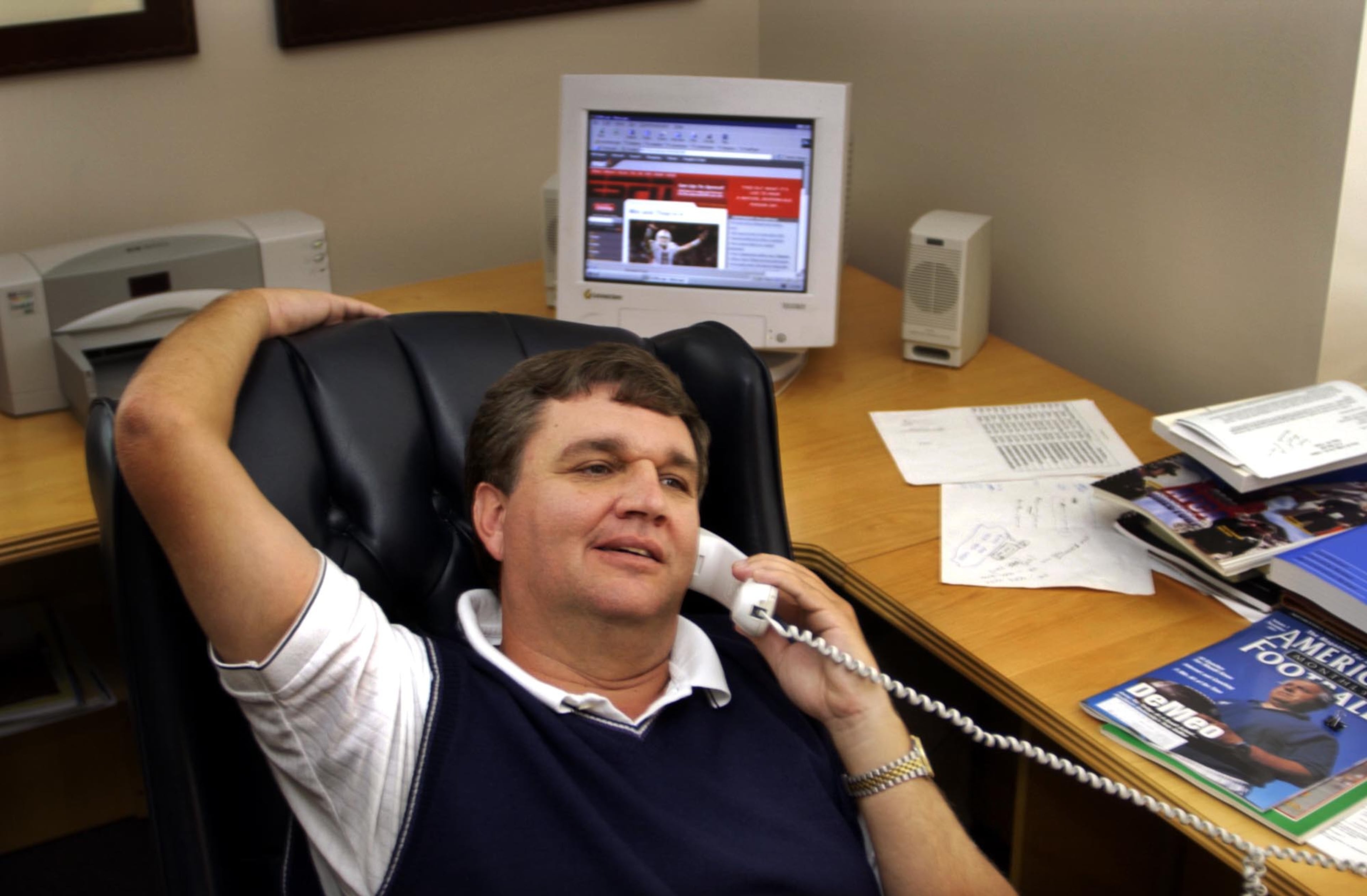 Paul Johnson talks on the phone in his office at Georgia Southern in 1996, his first season as coach of the Eagles. (AP Photo/Stephen Morton)