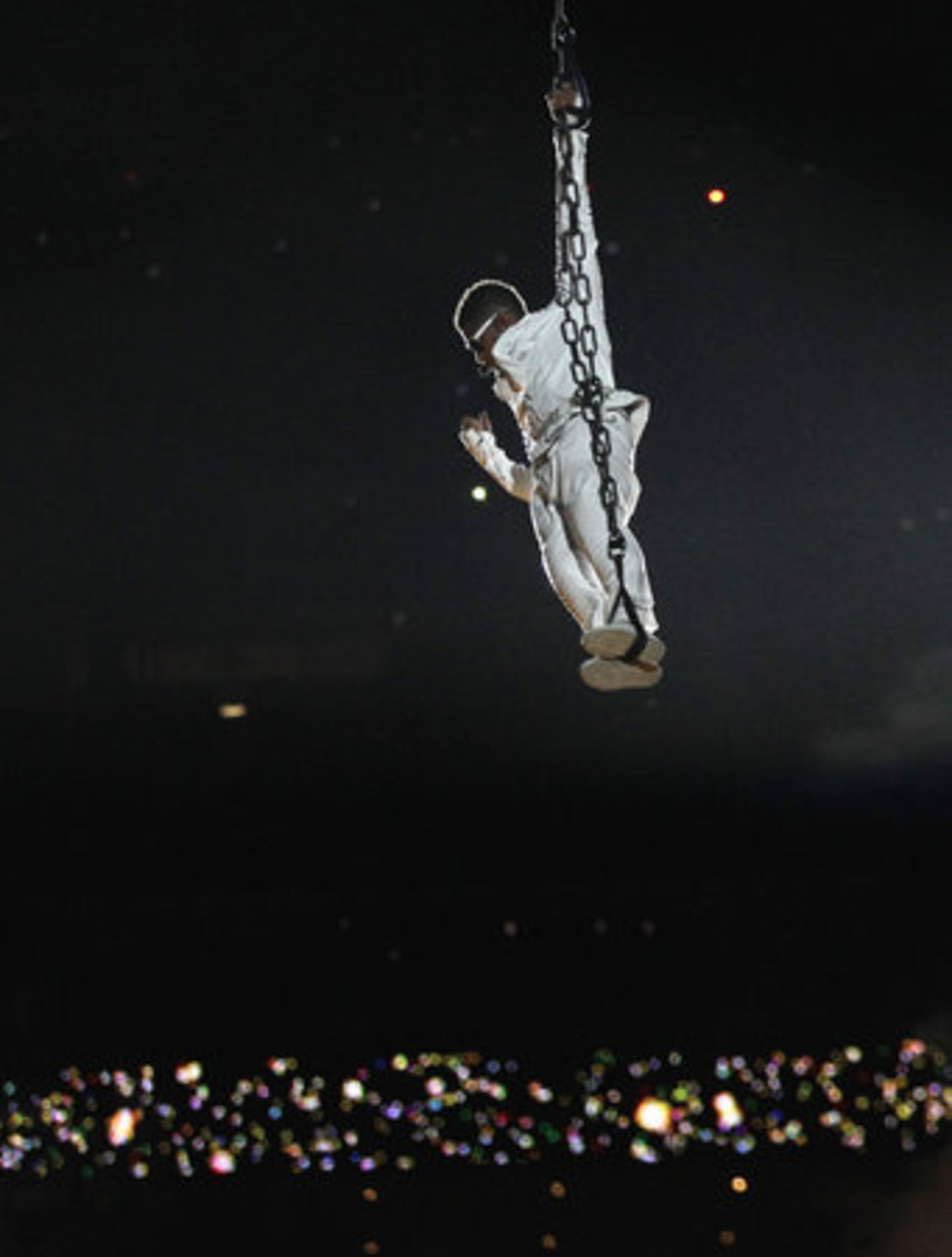 Usher proves he knows how to make an entrance as well as he's lowered to the Super Bowl halftime show stage.