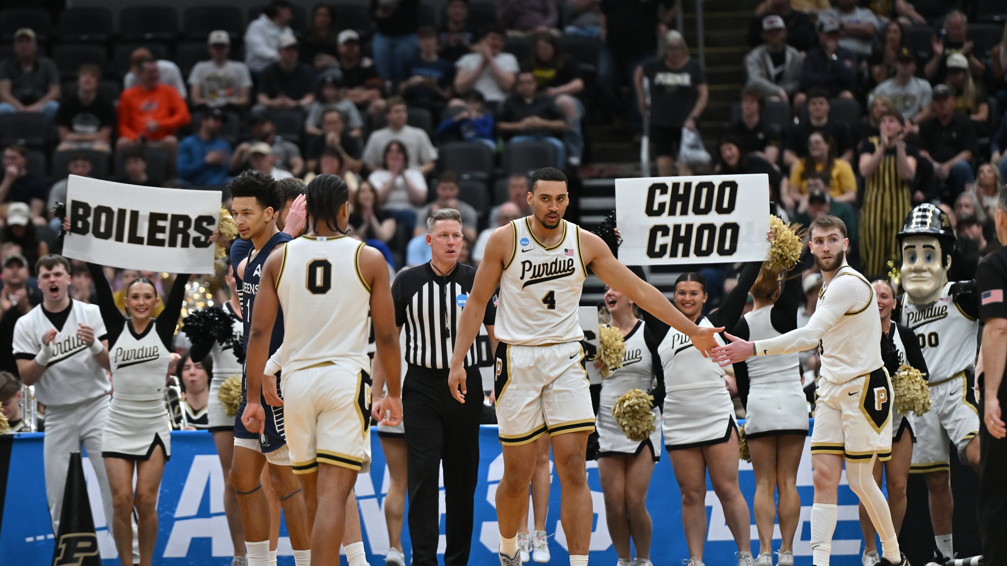 Purdue's Trey Kaufman-Renn (4) celebrates with teammate Braden Smith, right, and C.J. Cox (0) during the second half in the first round of the NCAA college basketball tournament against Queens University, Friday, March 20, 2026, in St. Louis. (AP Photo/Ali Overstreet)