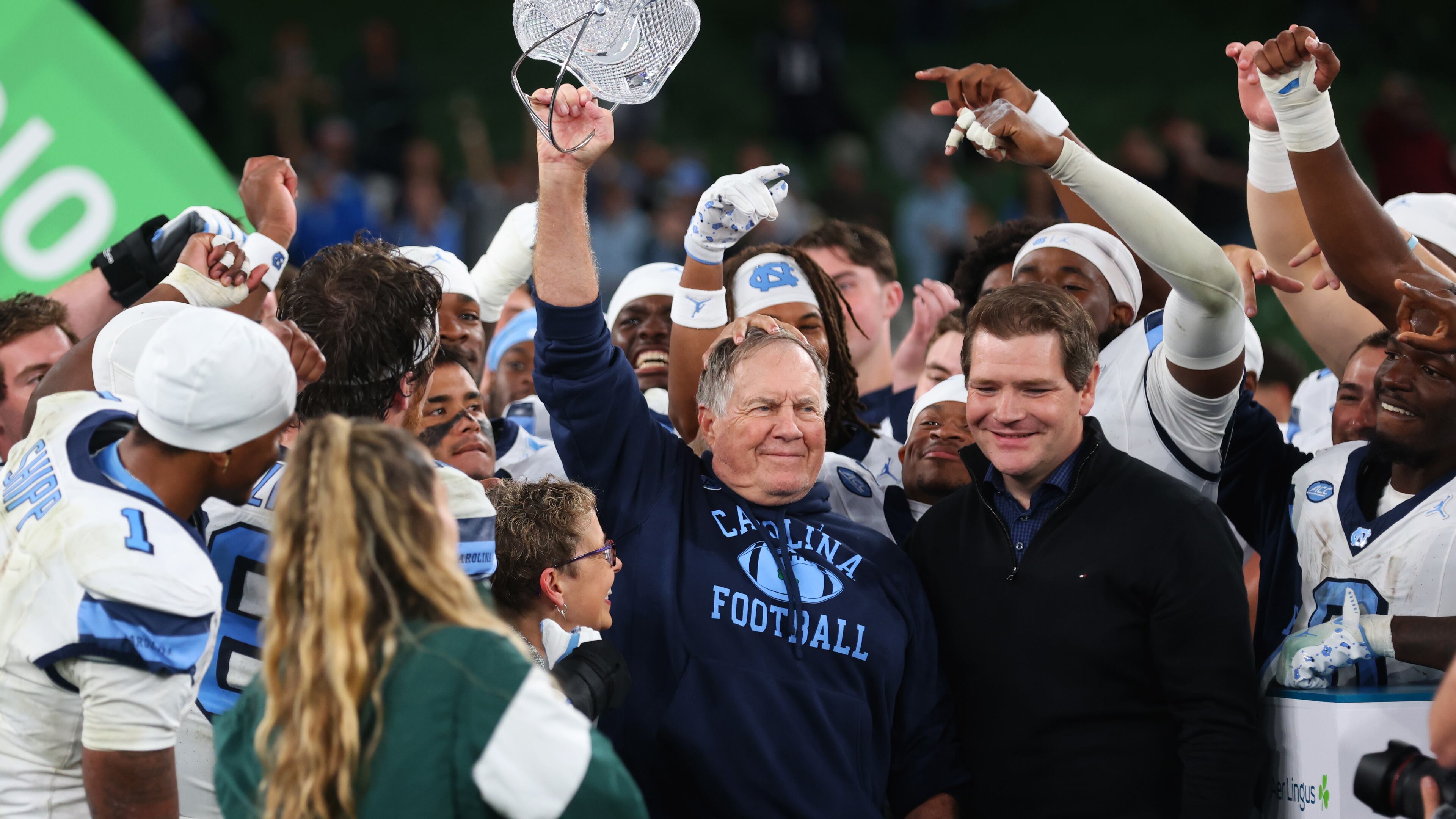 North Carolina head coach Bill Belichick, center, and his team celebrate after defeating TCU in an NCAA college football game in Dublin, Ireland, Saturday, Aug. 29, 2026. (AP Photo/Peter Morrison)