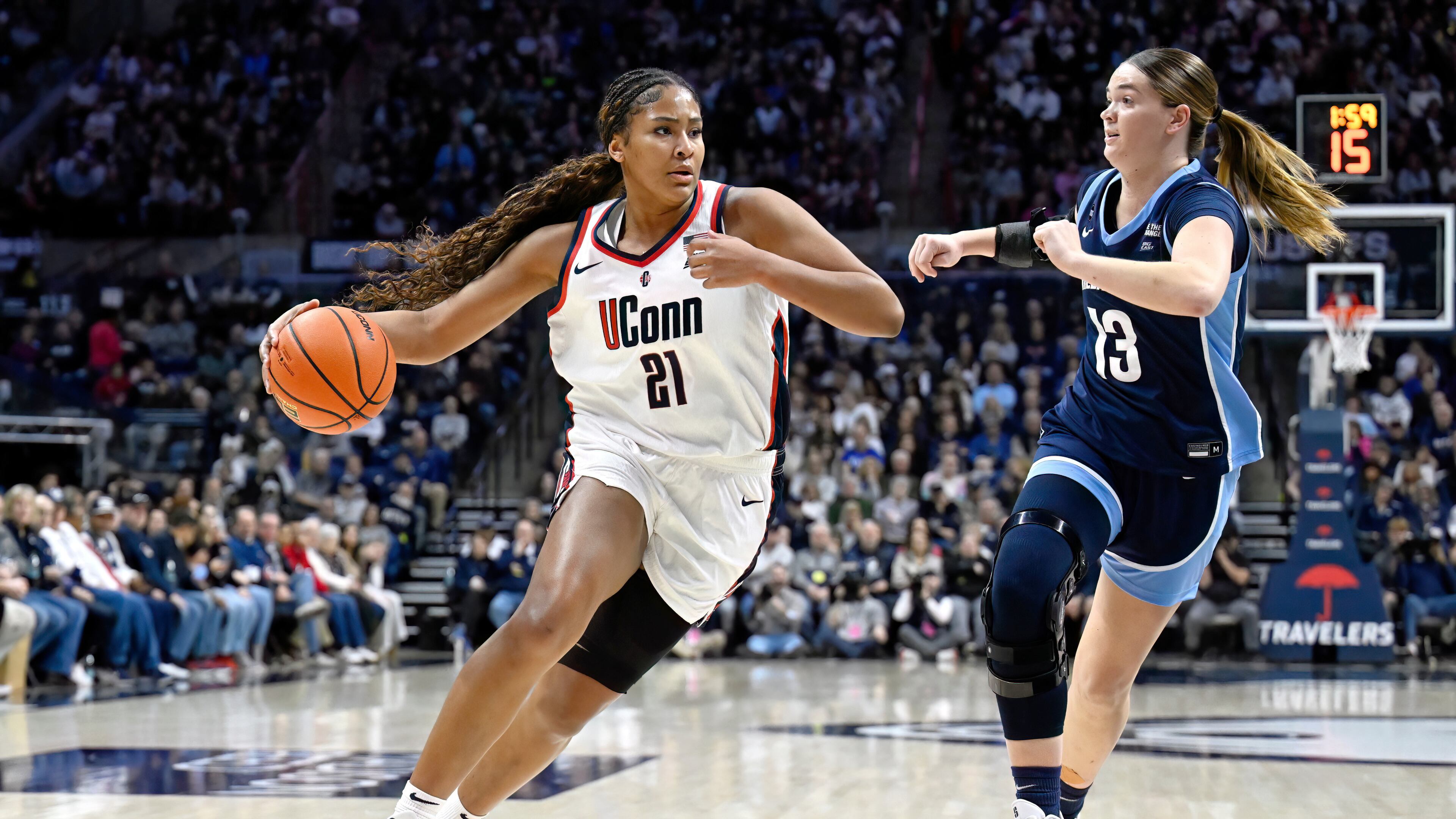 FILE - UConn forward Sarah Strong (21) is guarded by Villanova forward Brynn McCurry (13) in the first half of an NCAA college basketball game, Thursday, Jan. 15, 2026, in Storrs, Conn. (AP Photo/Jessica Hill, File)