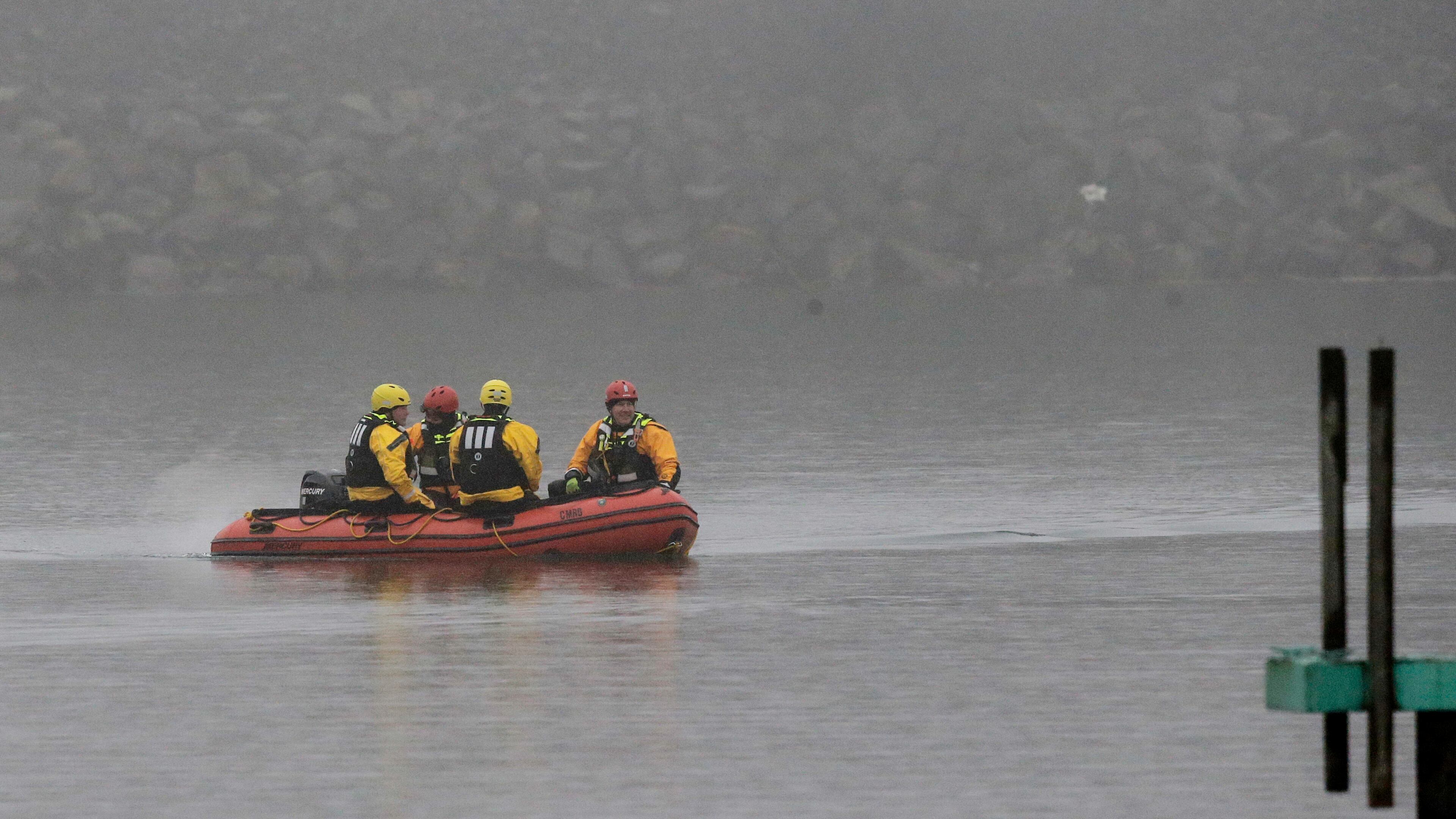 A boat carrying a recovery team rides on the shoreline of Lake Erie, Tuesday, Jan. 3, 2017, in Cleveland. Cleveland officials say the search for a plane carrying six people that disappeared last week over Lake Erie has resumed. Tuesday marks the third straight day that conditions have allowed recovery teams to search the lake for a Columbus-bound Cessna 525 Citation that vanished from radar shortly after takeoff Thursday night from Burke Lakefront Airport. (AP Photo/Tony Dejak)