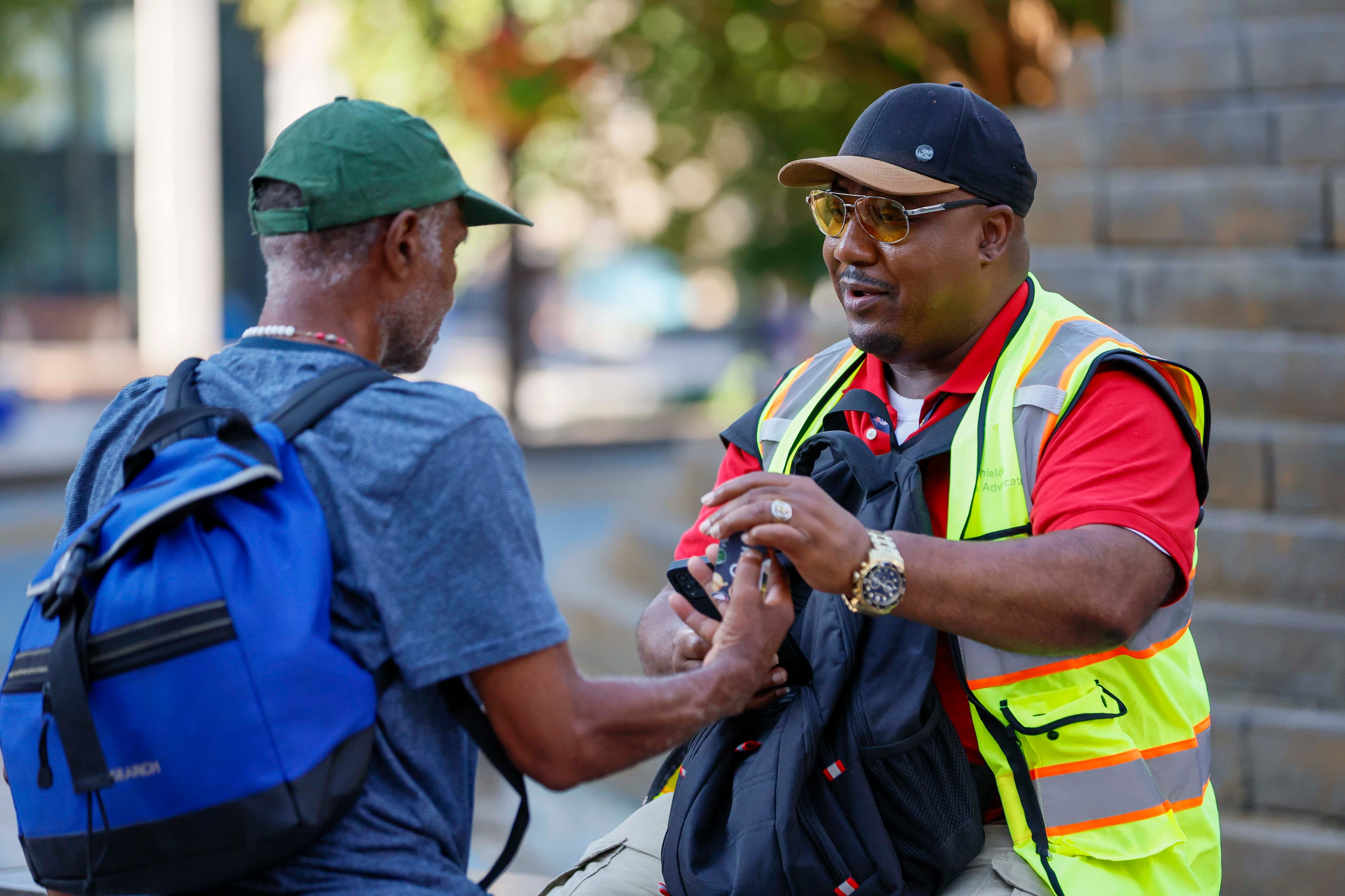 Richard DeShields (right), chair of the Client Advisory Council for Partners for Home, conducts a survey of unsheltered people at Woodruff Park on Monday, July 7, 2025. (Miguel Martinez/AJC)