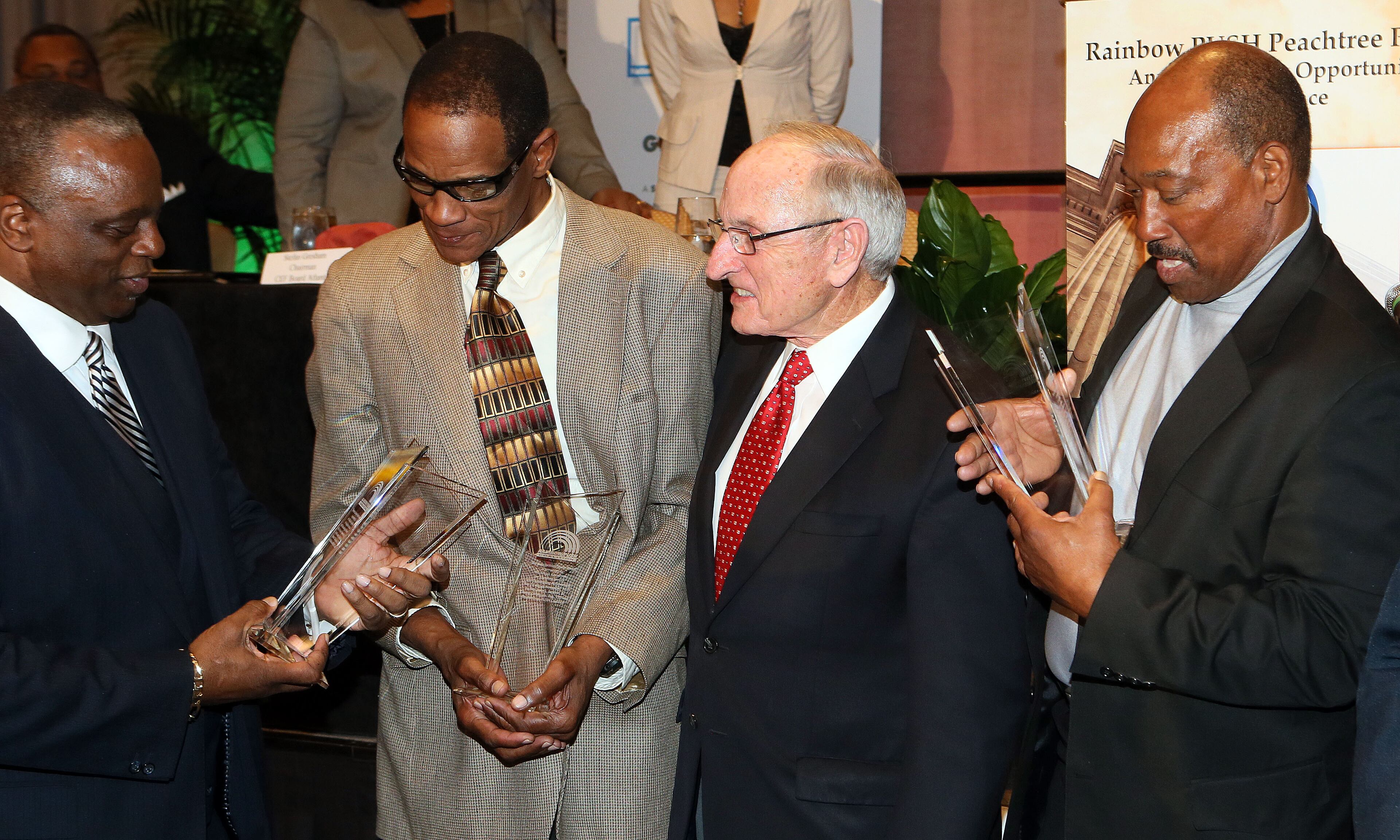 Larry West, Richard Appleby, former coach Vince Dooley and Horace King receive their awards during a ceremony where the Rainbow PUSH Coalition honored five alumni of the University of Georgia who were the first black students to play football on scholarship at the institution during the Sports Awards Luncheon and Youth Talent Showcase at the Hyatt Regency in Atlanta on Saturday November 2nd, 2013. The players were reunited with their former coach, Vince Dooley, who presented their awards.