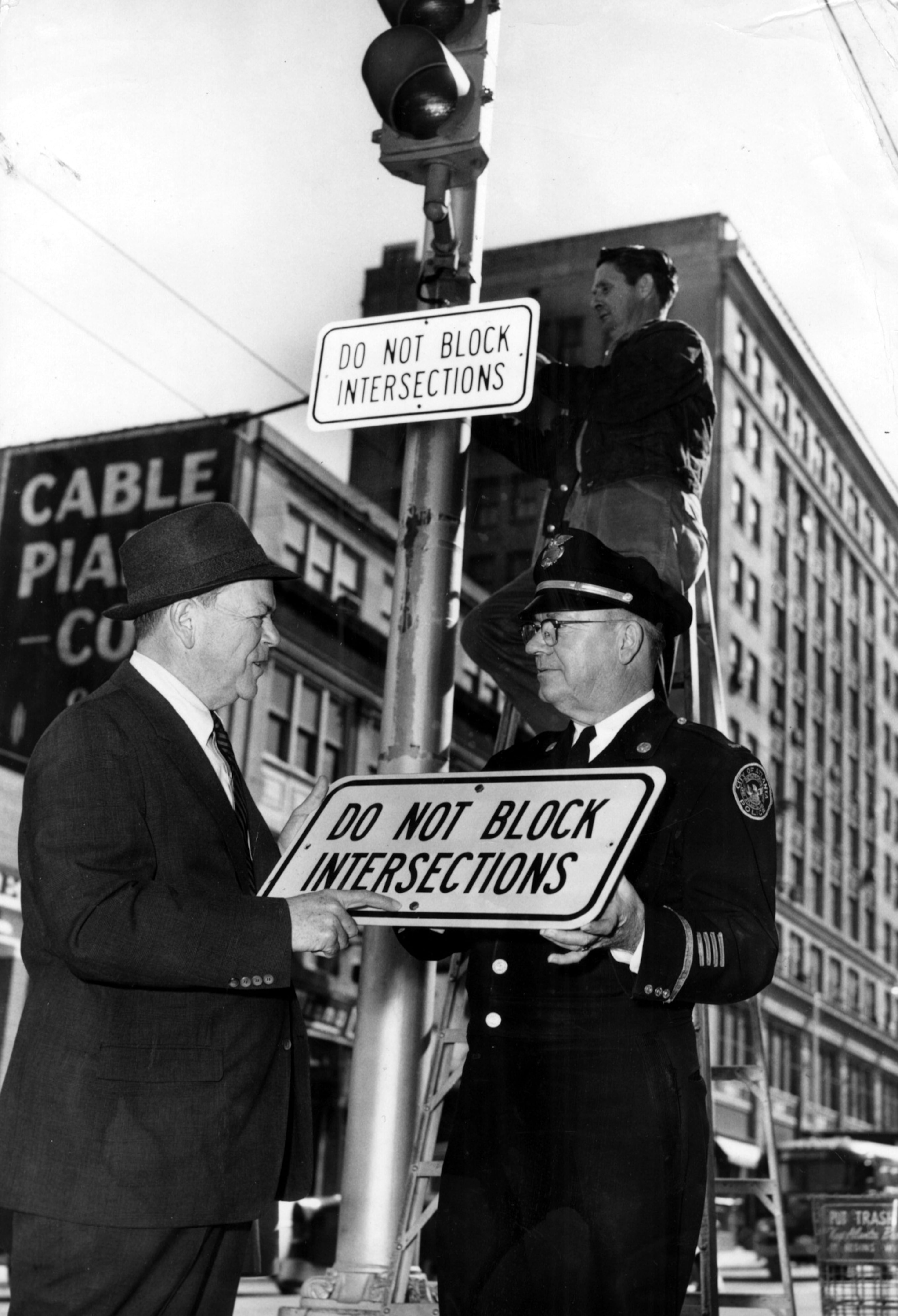 R. R. Snodgrass (left) and Supt. T.J. Sikes put up the first "DO NOT BLOCK INTERSECTIONS" sign in downtown Atlanta, Feb. 1959. And we know you are paying close attention to them. All of them. Ahem.
