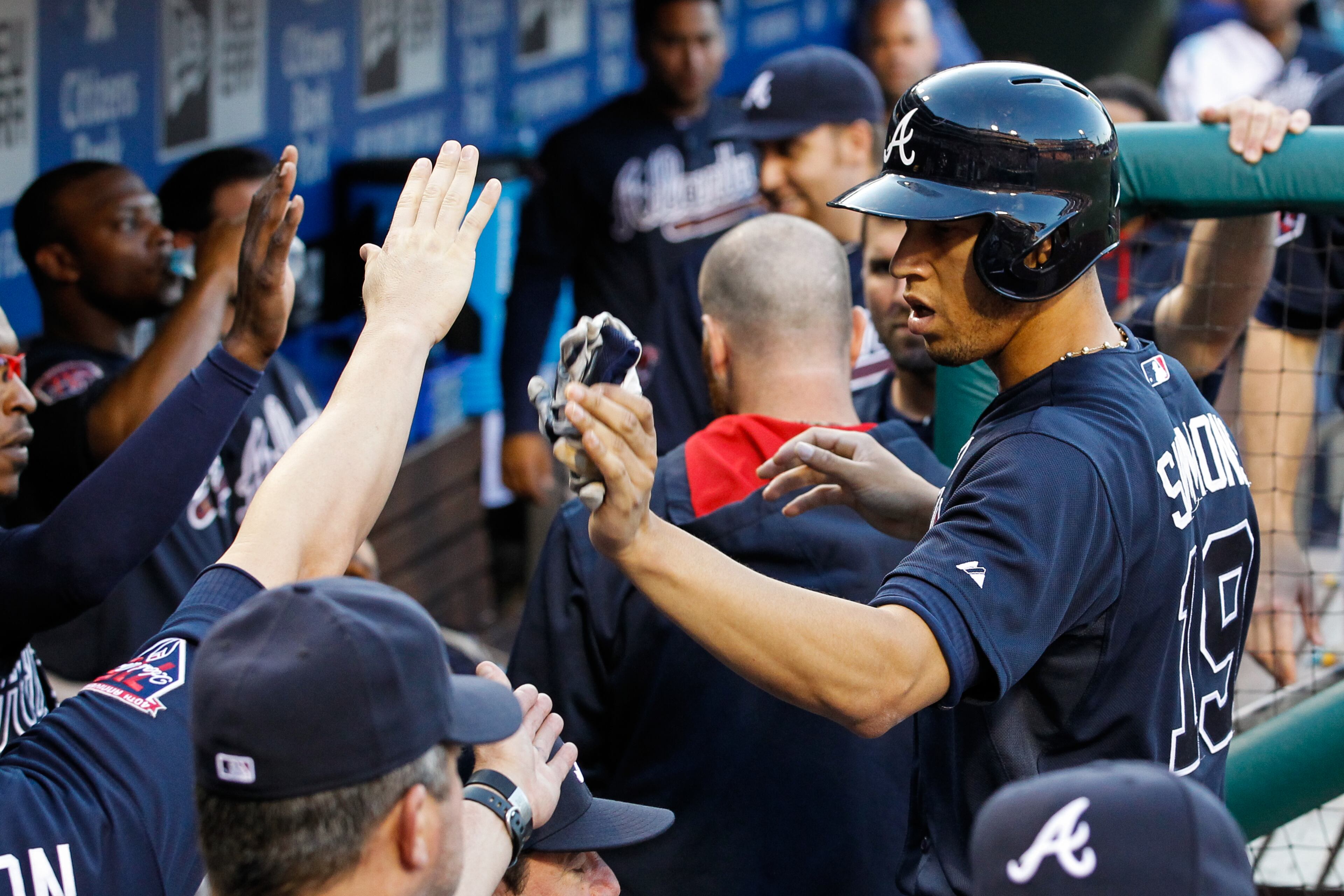 PHILADELPHIA, PA - JUNE 27: Andrelton Simmons #19 of the Atlanta Braves is congratulated by teammates in the dugout after scoring a run in the second inning of the game against the Philadelphia Phillies at Citizens Bank Park on June 27, 2014 in Philadelphia, Pennsylvania. (Photo by Brian Garfinkel/Getty Images)