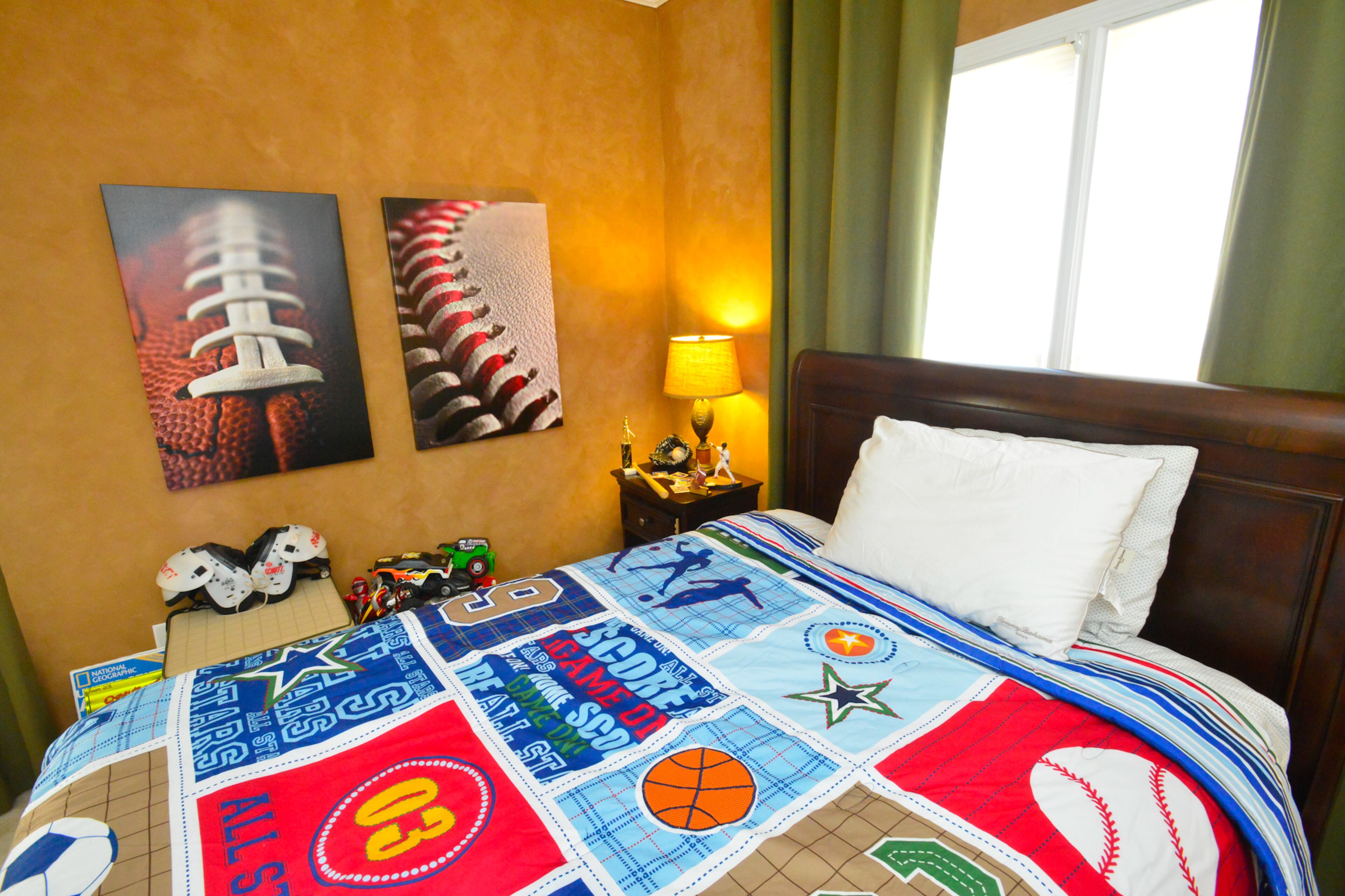 The Mitchells' son, Sean, has a sports-themed bedroom, featuring a bed by Lea Furniture, bedding by Eastern Accents and artwork by Malanta Knowles.