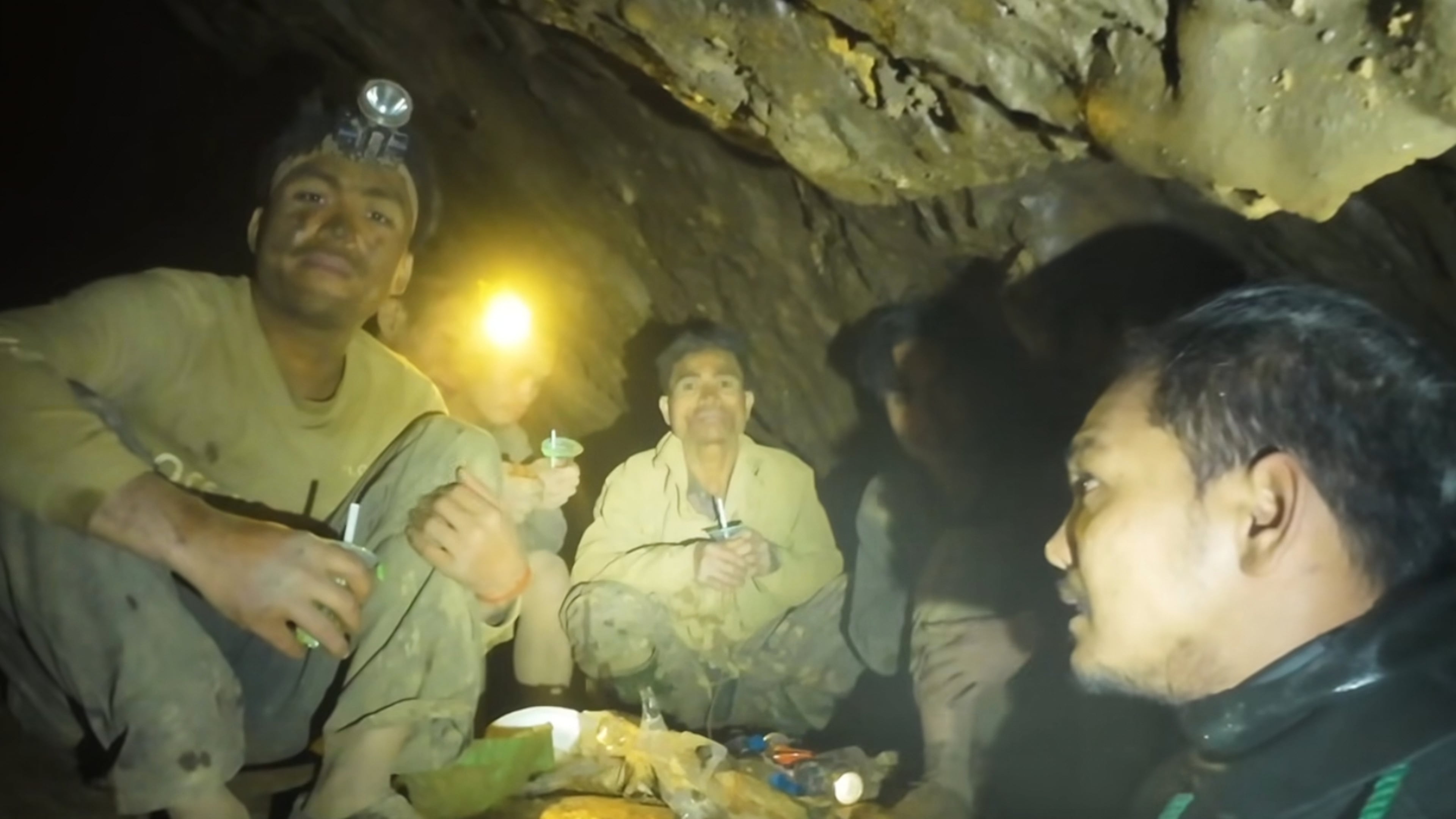 This image made from the video provided by Benz Norrased Palasing Seascout Diving shows rescuers speaking to the villagers who were trapped and found in a flooded cave in Xaisomboun province, Laos, Wednesday, May 27, 2026. (Benz Norrased Palasing Seascout Diving via AP)