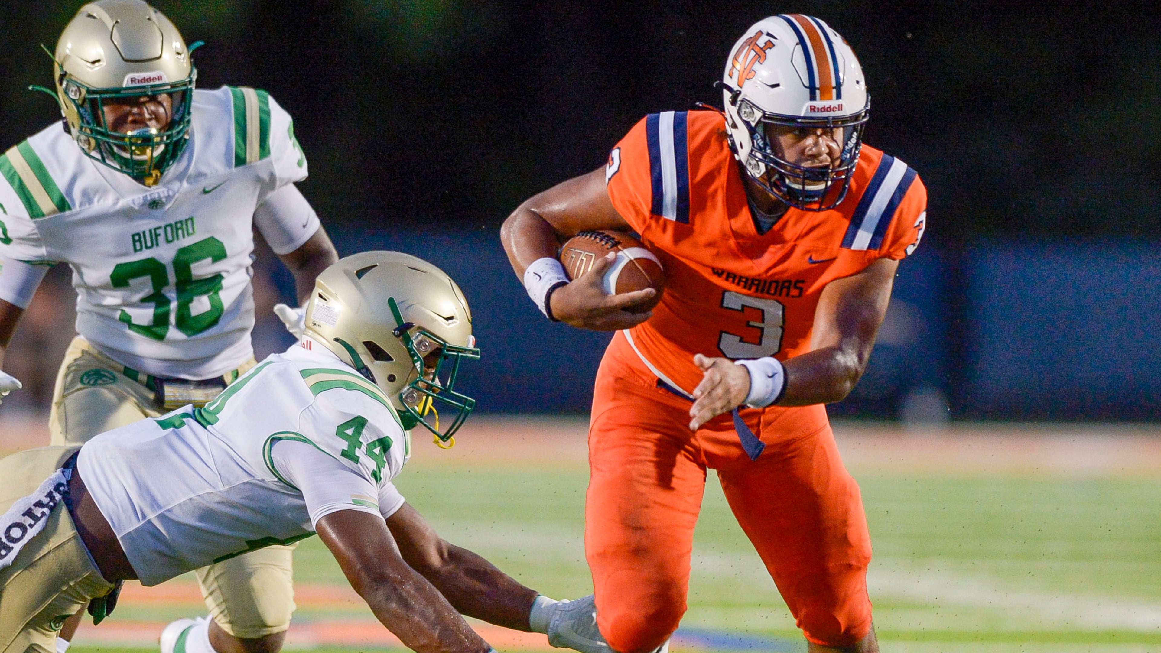 North Cobb QB Malachi Singleton (3) dodges a tackle from Buford linebacker Aubrey Smith (44) in the first half of Friday's game. North Cobb, a Class 7A school, won 28-14. Buford is ranked No. 3 in 6A. (Daniel Varnado/Special to the AJC)