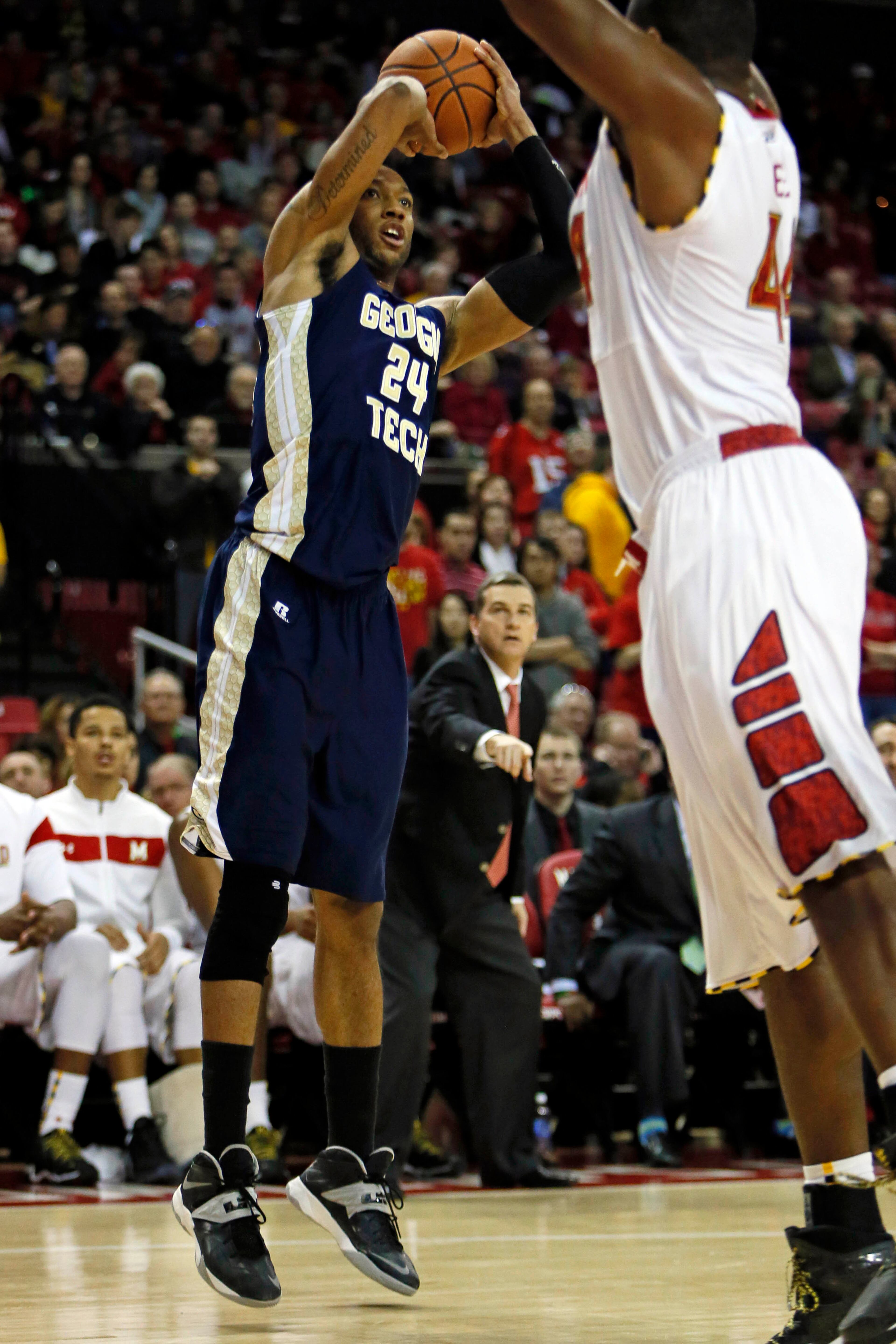 Georgia Tech Yellow Jackets forward Kammeon Holsey (24) attempts a shot against Maryland Terrapins forward Shaquille Cleare (44) at Comcast Center.