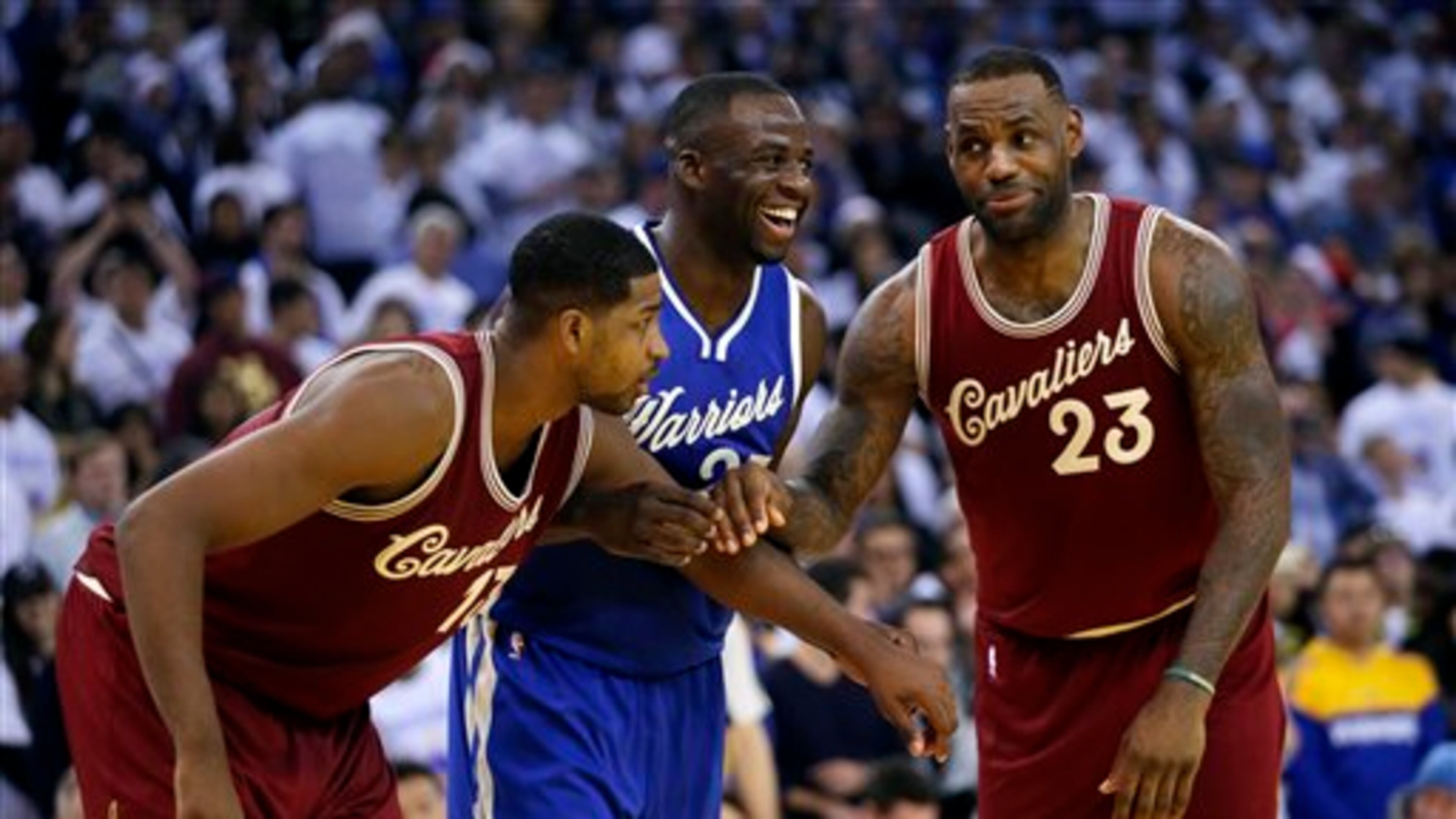 Golden State Warriors' Draymond Green (23) jokes with Cleveland Cavaliers' LeBron James (23) during the second half of an NBA basketball game Friday, Dec. 25, 2015, in Oakland, Calif. (AP Photo/Marcio Jose Sanchez)