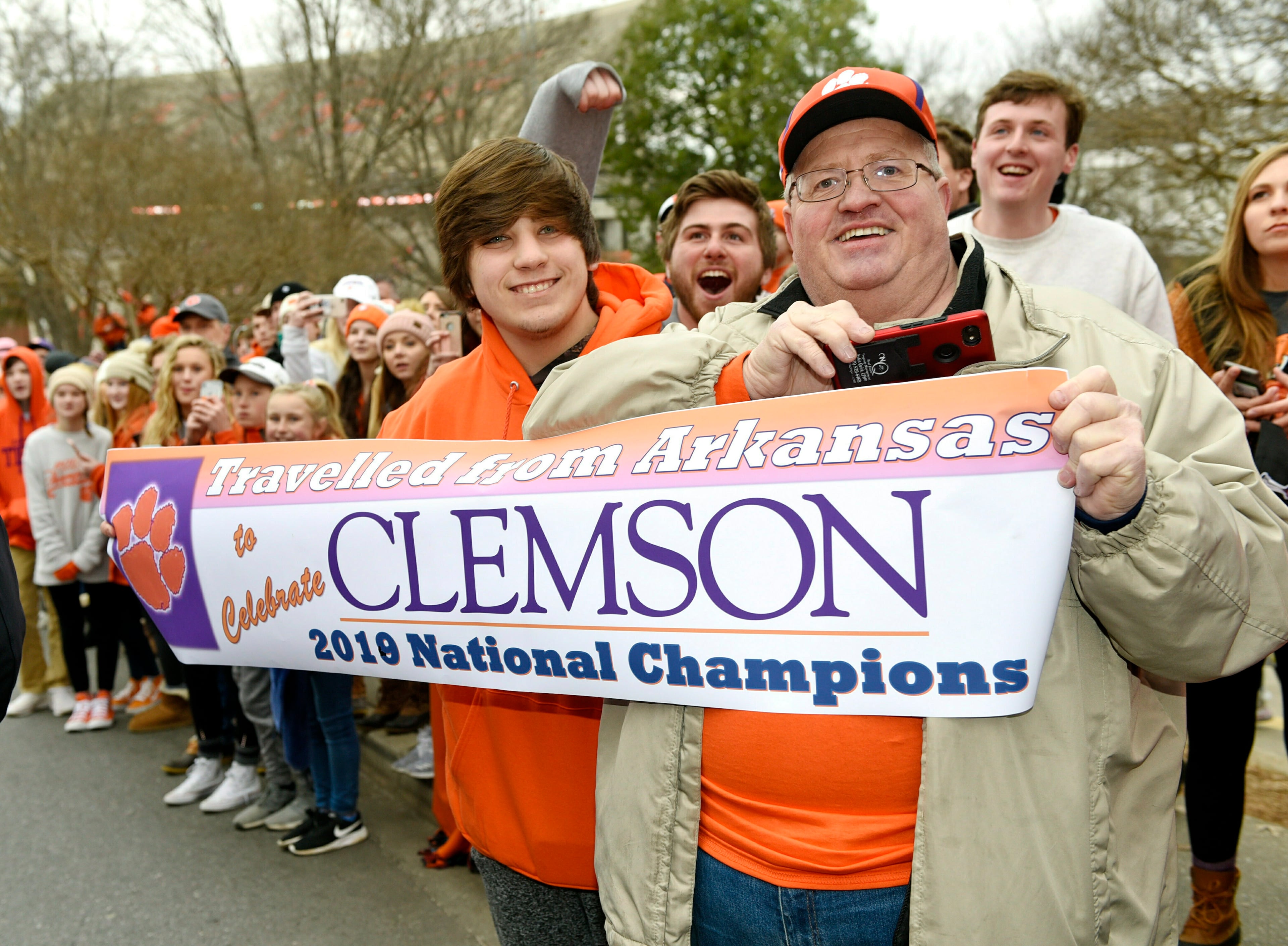 Jerry Halsell, right, and his grandson Nick Oliver, traveled from Paragould, Ark., to attend the parade held in honor of Clemson, Saturday, Jan. 12, 2019, in Clemson, S.C., The Tigers defeated Alabama 44-16 in the College Football Playoff championship game Monday Jan. 7. (AP Photo/Richard Shiro)