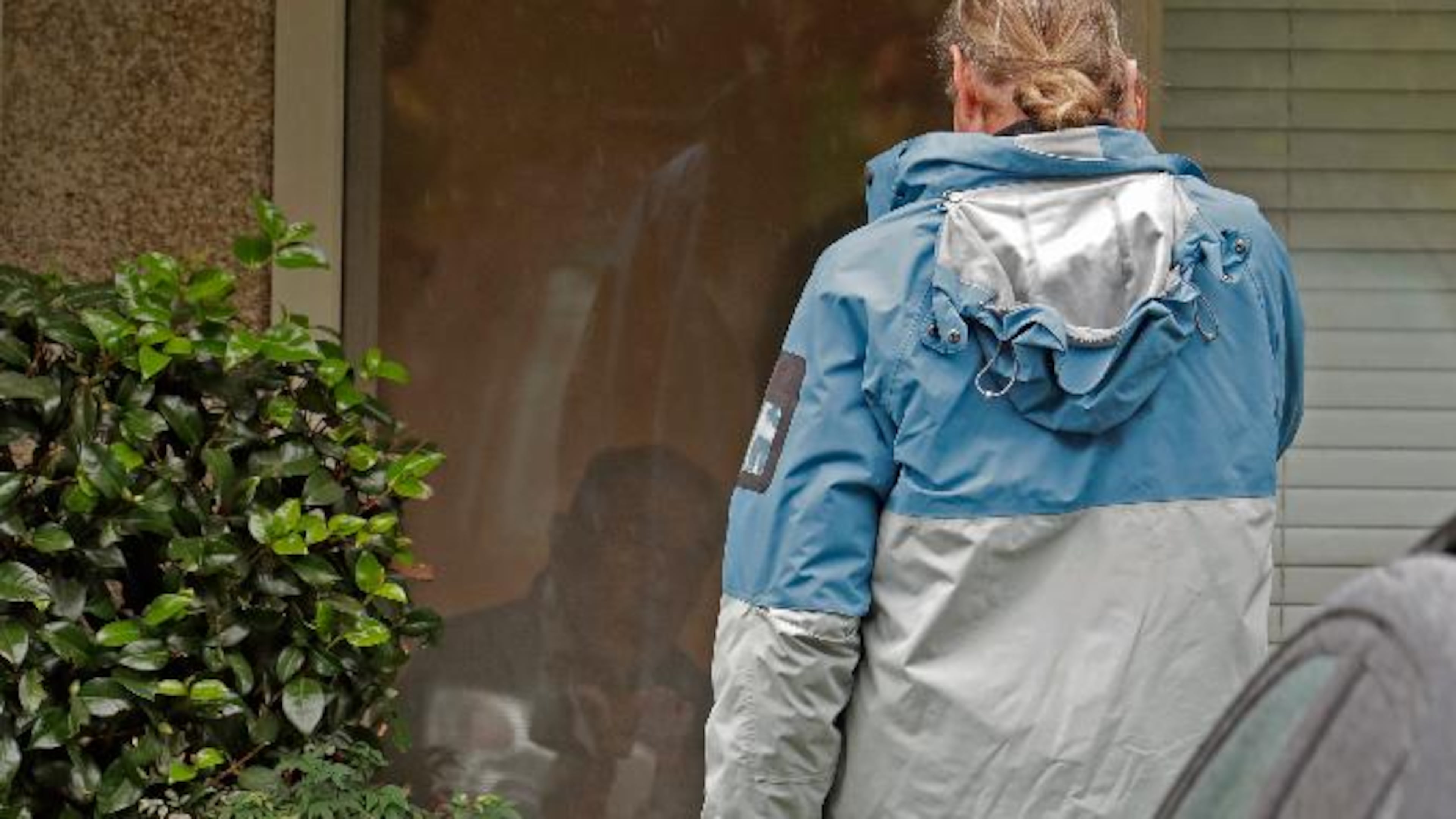 Gene Campbell, left, watches through his window as he talks on the phone with son Charlie at the Life Care Center in Kirkland, Washington. Charlie and his mother Dorothy came to visit Gene on Friday. Charlie later told reporters that his father, who had not yet been tested, was showing symptoms of the virus and would be taken to a hospital.