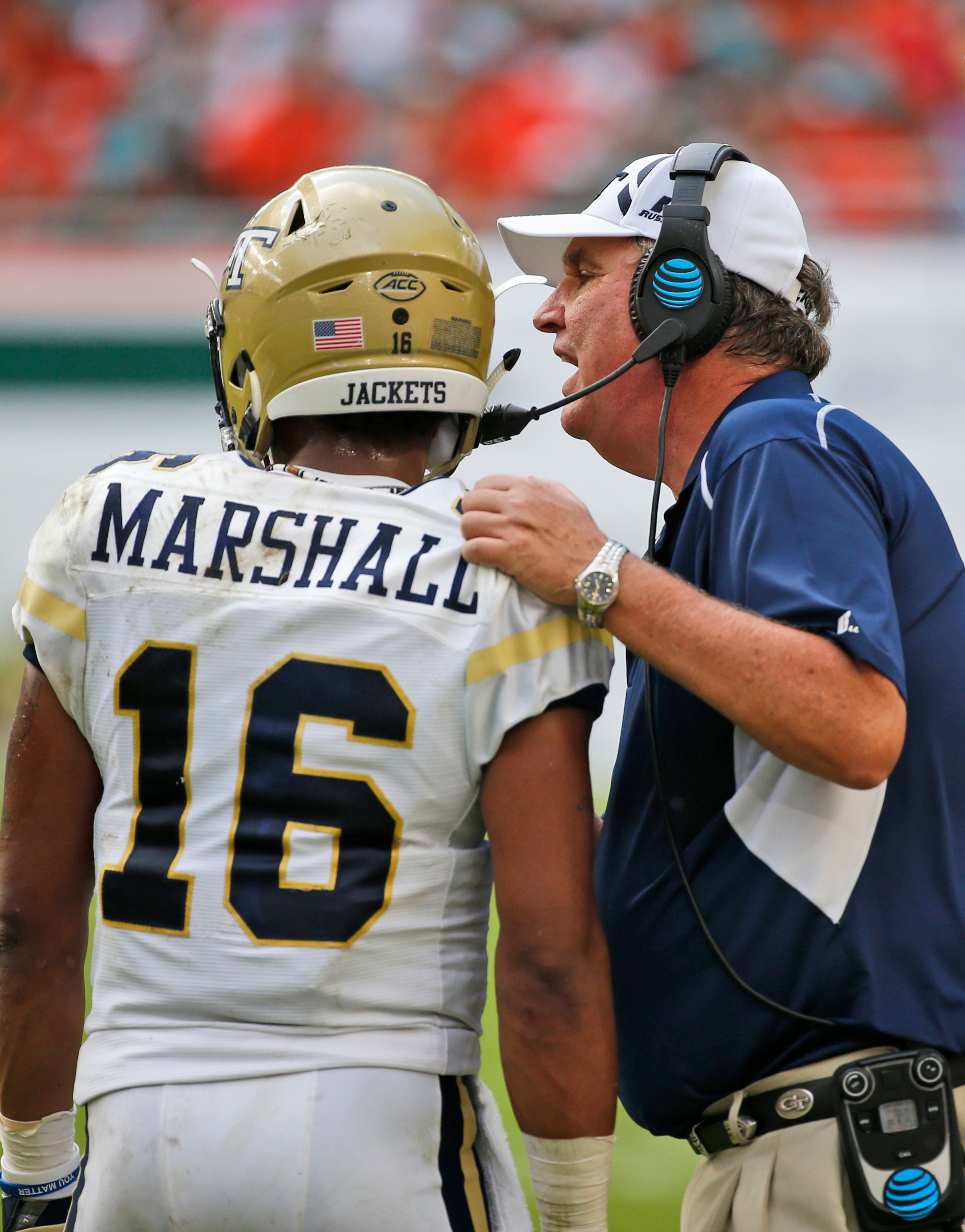 Georgia Tech head coach Paul Johnson talks with quarterback TaQuon Marshall during the first half of Saturday's game. (AP Photo/Wilfredo Lee)