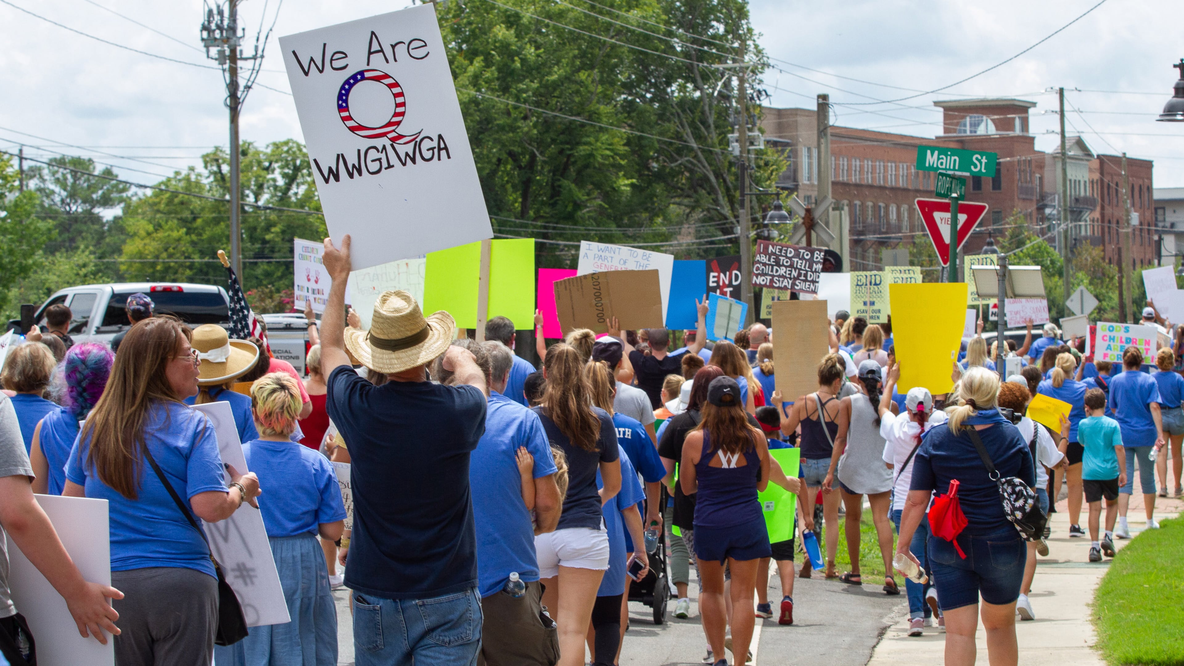 Standing with the Children protesters march down Rope Mill Rd from Woodstock Elementary on their way to Park at City Center in Woodstock Saturday, August 22, 2020. STEVE SCHAEFER FOR THE ATLANTA JOURNAL-CONSTITUTION