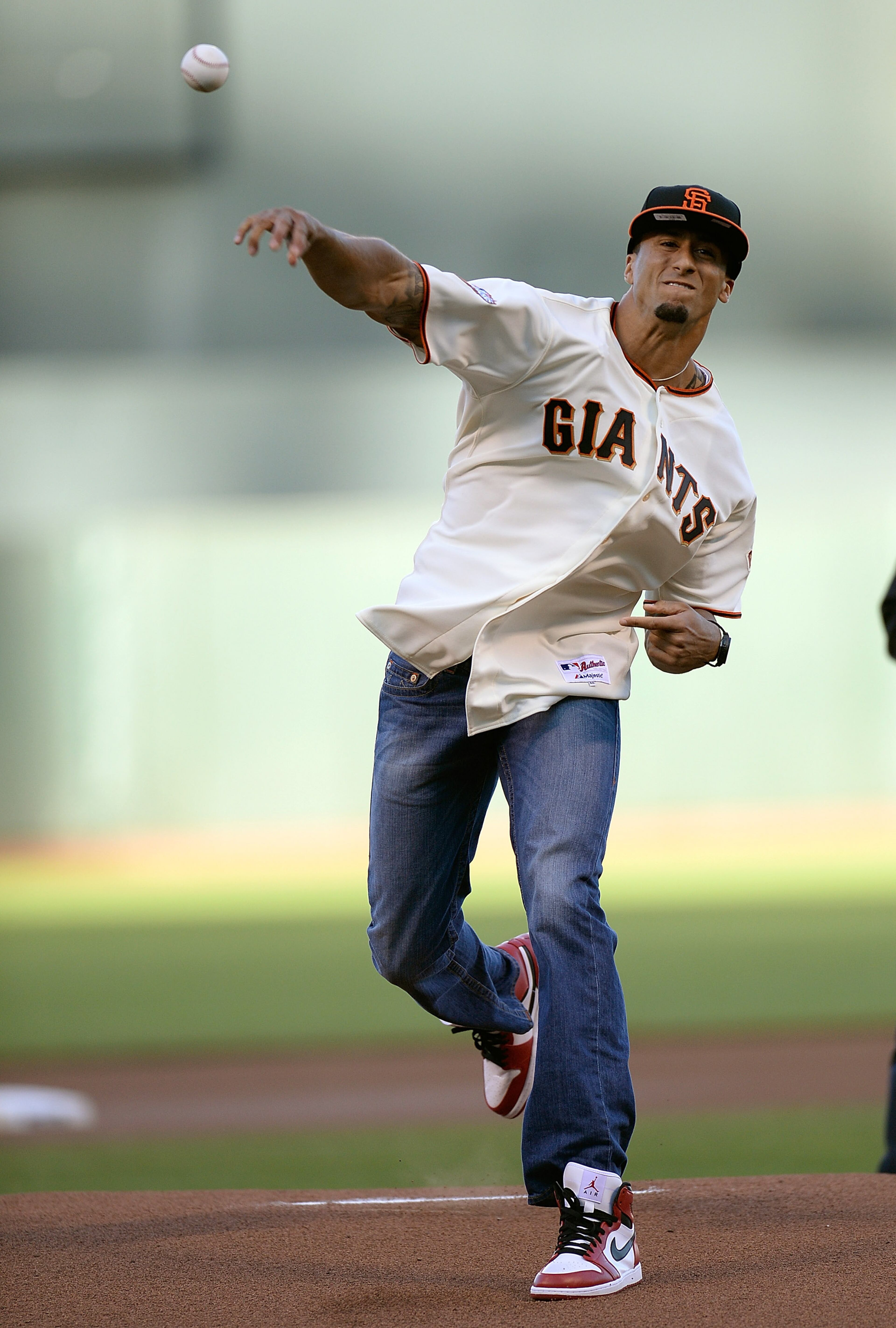 Quarterback Colin Kaepernick of the San Francisco 49ers throws out the ceremonial first pitch before a Major League Baseball game between the Miami Marlins and San Francisco Giants at AT&T Park on June 21, 2013 in San Francisco, California.