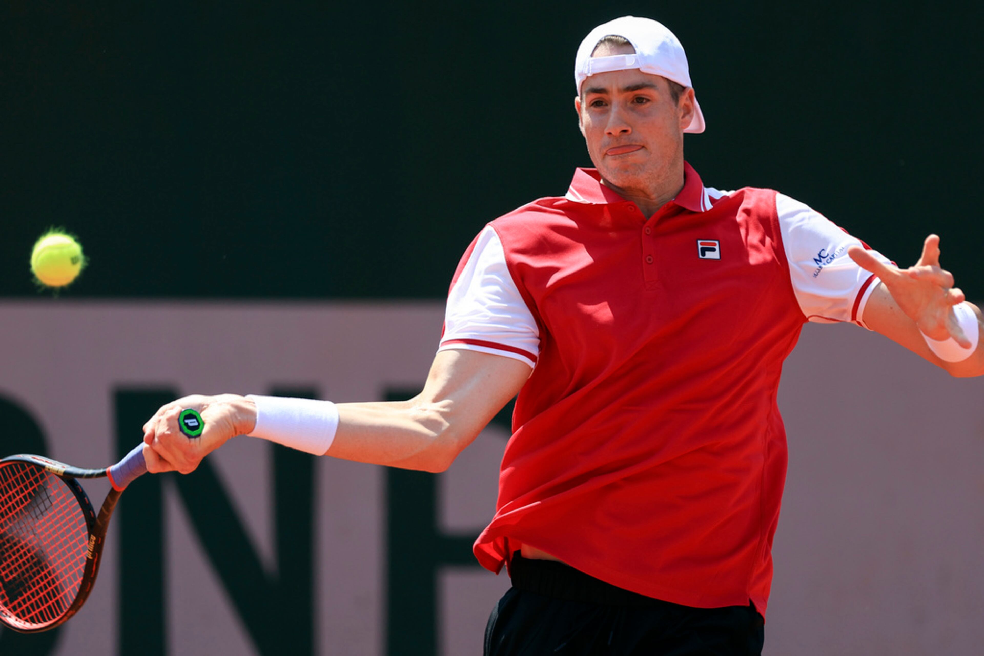 John Isner of the U.S. plays a shot against Portugal's Nuno Borges during their first round match of the French Open tennis tournament at the Roland Garros stadium in Paris, Sunday, May 28, 2023. (AP Photo/Aurelien Morissard)