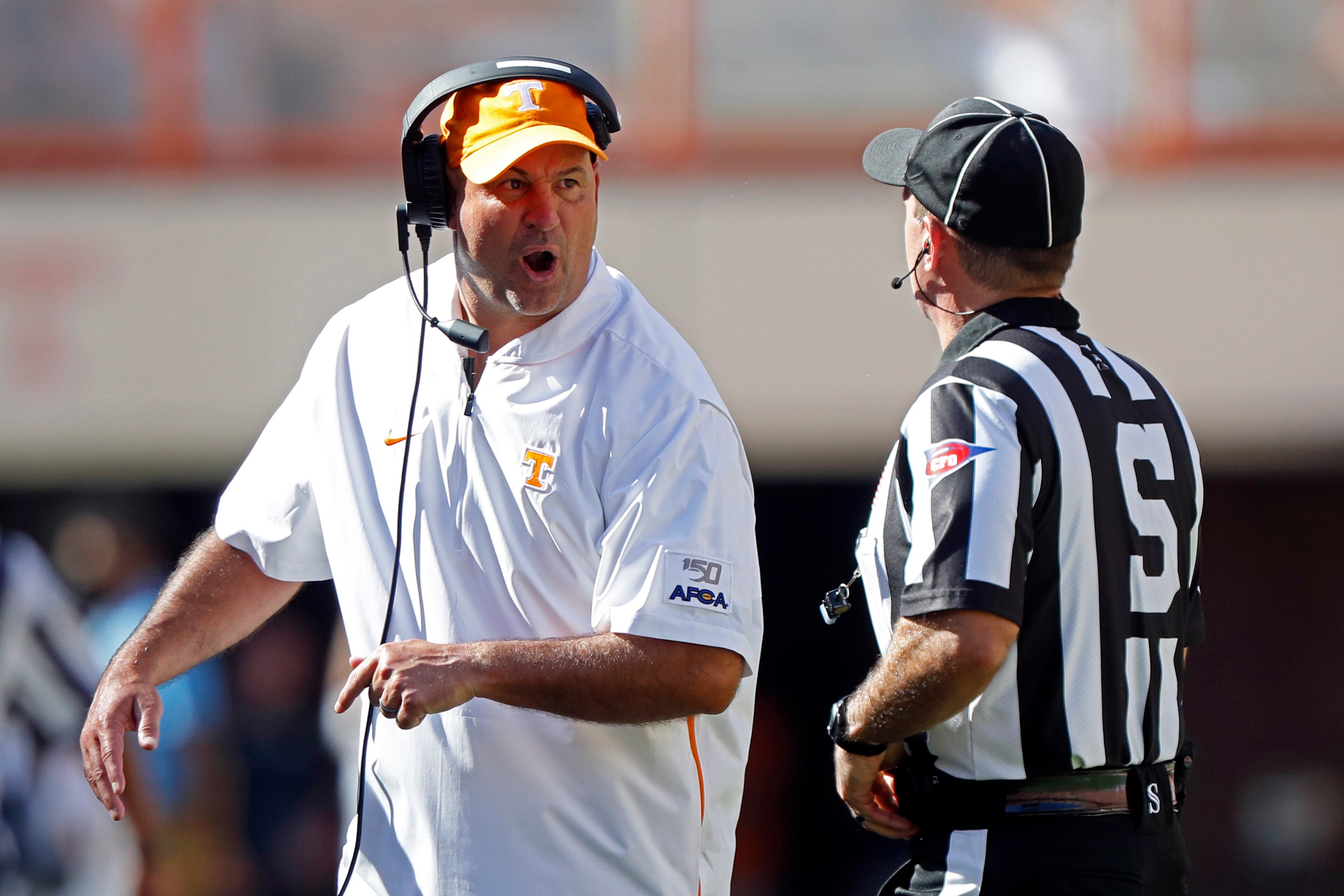 Tennessee head coach Jeremy Pruitt yells at side judge Eduardo Balbis in the first half of an NCAA college football game against Georgia State, Saturday, Aug. 31, 2019, in Knoxville, Tenn. (AP Photo/Wade Payne)
