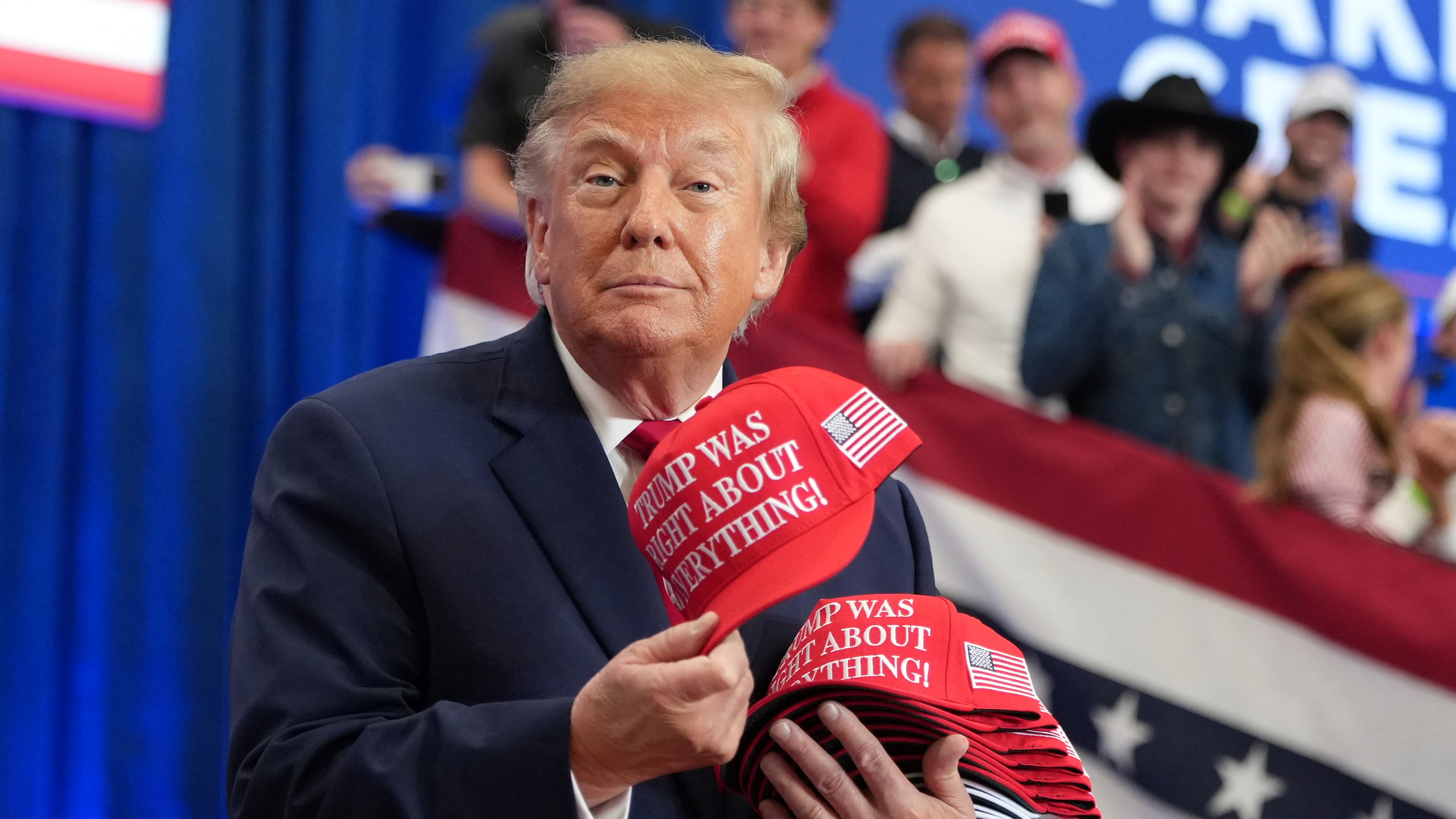 President Donald Trump tosses hats into the crowd as he arrives at a campaign rally at the Lubbock Memorial Civic Center, Tuesday, Oct. 27, 2026, in Lubbock, Texas. (AP Photo/Alex Brandon)