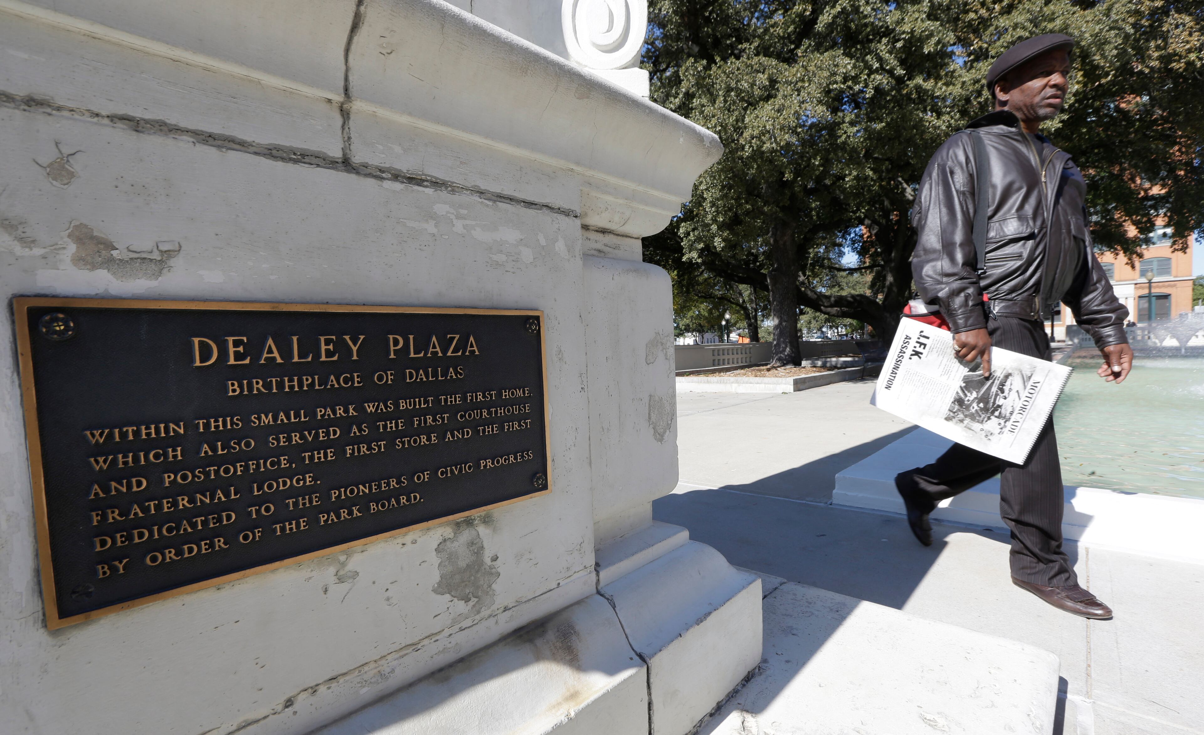 A historical plaque tells of the pioneer history of Dealey Plaza in Dallas in 2013. The park was where Dallas was founded in 1841 and would also become the site of the assassination of JFK on Nov. 22, 1963. (AP Photo/LM Otero)