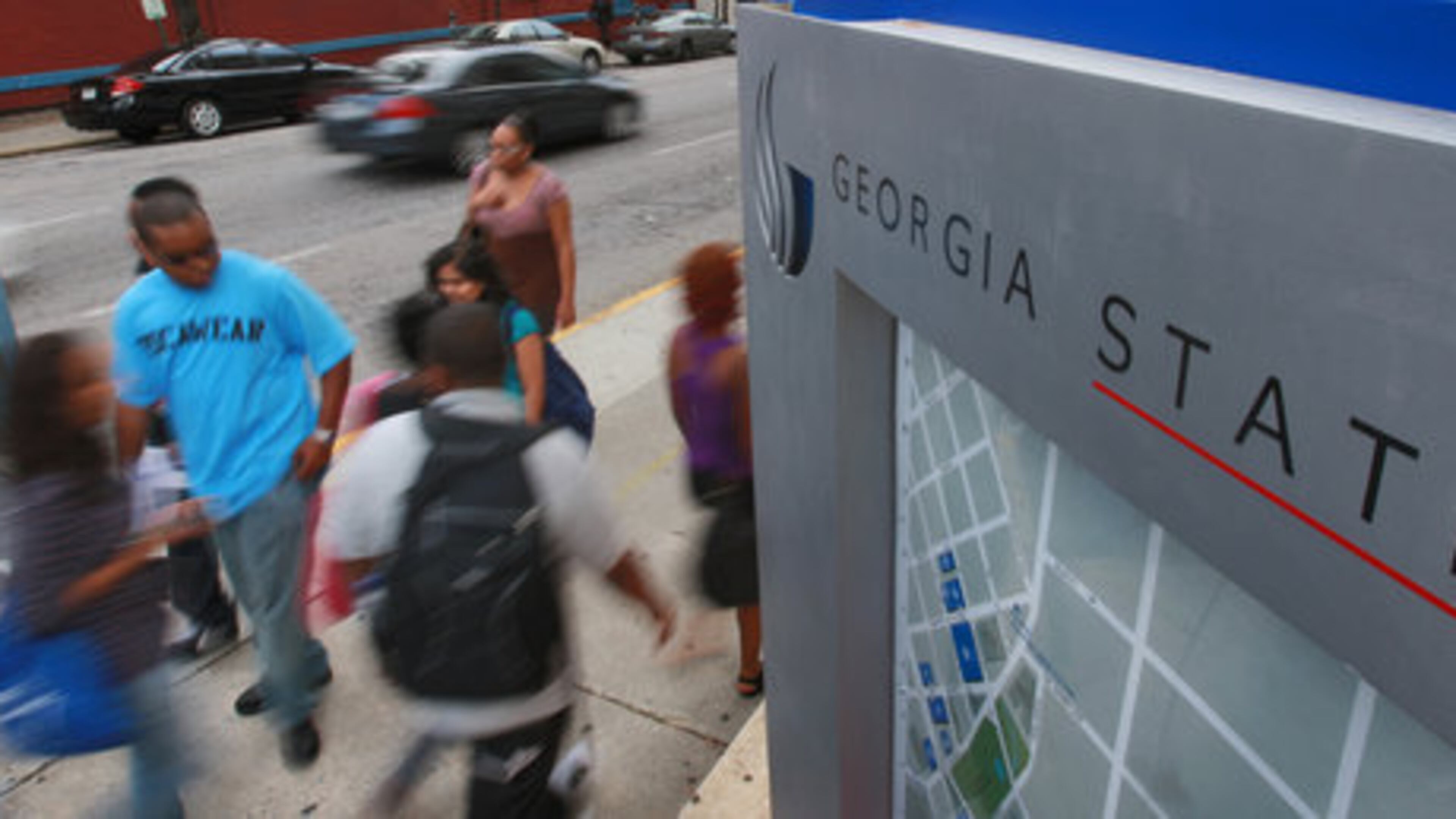 Georgia State students whiz past the corner of Peachtree Center Avenue and Decatur Street.
