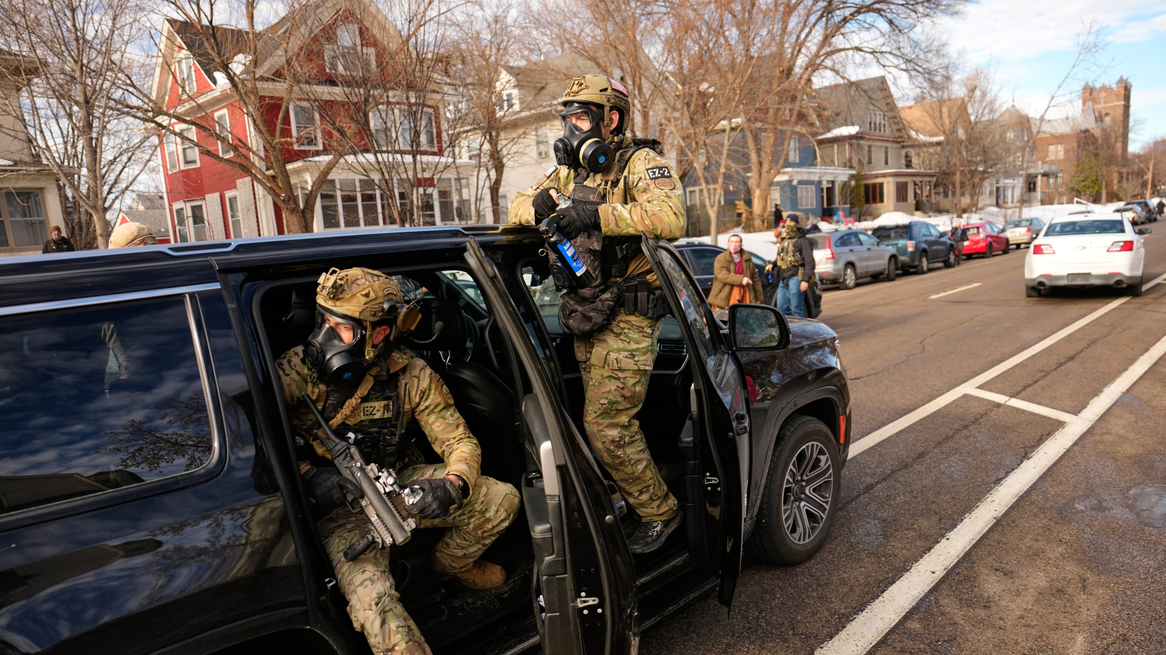 Federal immigration officers get in a car as they prepare to deploy tear gas at a protest, Monday, Jan. 12, 2026, in Minneapolis. (AP Photo/John Locher)
