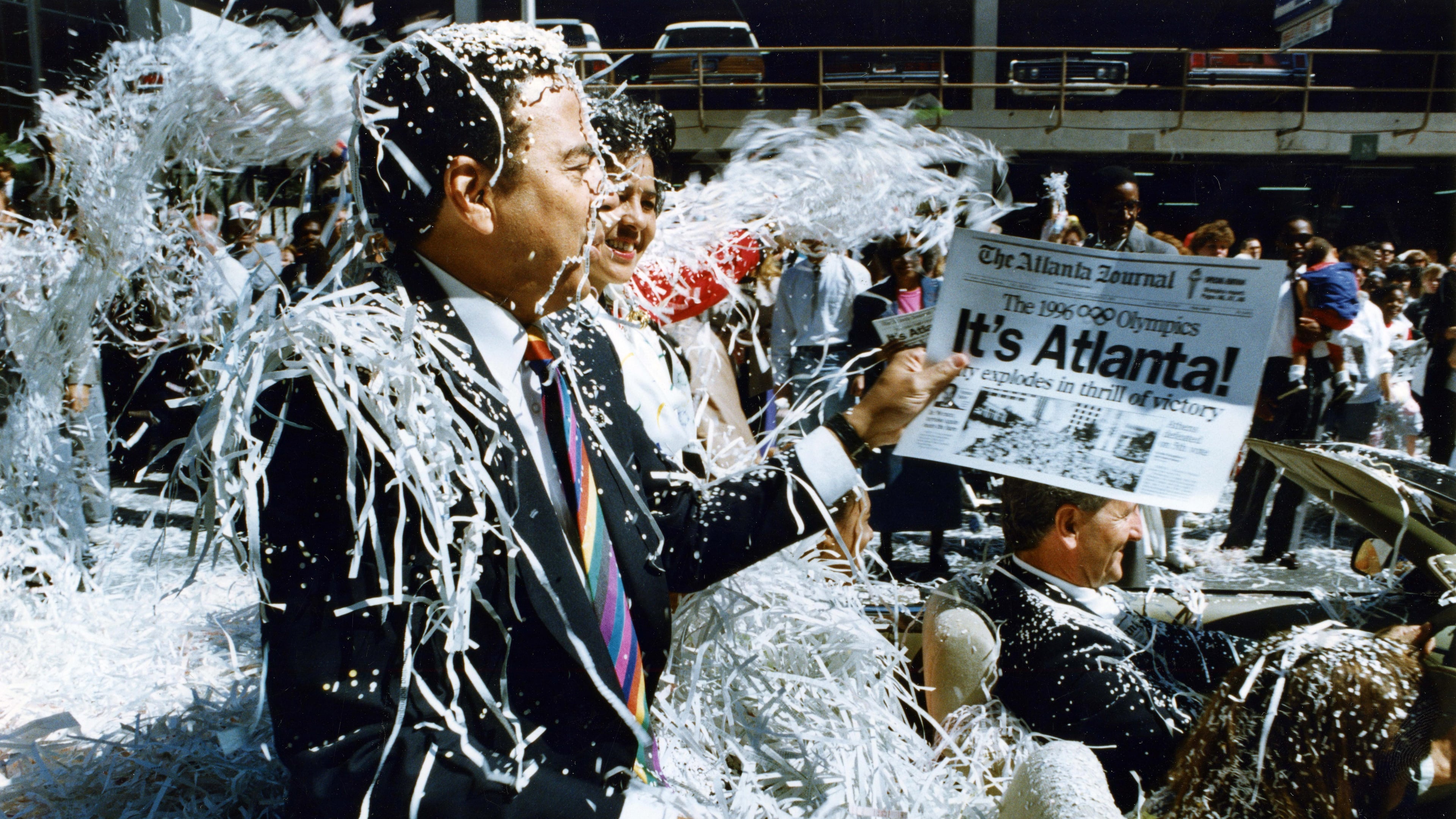 Former Mayor Andrew Young rides down Marietta Street in the Atlanta Olympic Day parade on Sept. 24, 1990. (Eric Williams/AJC File)