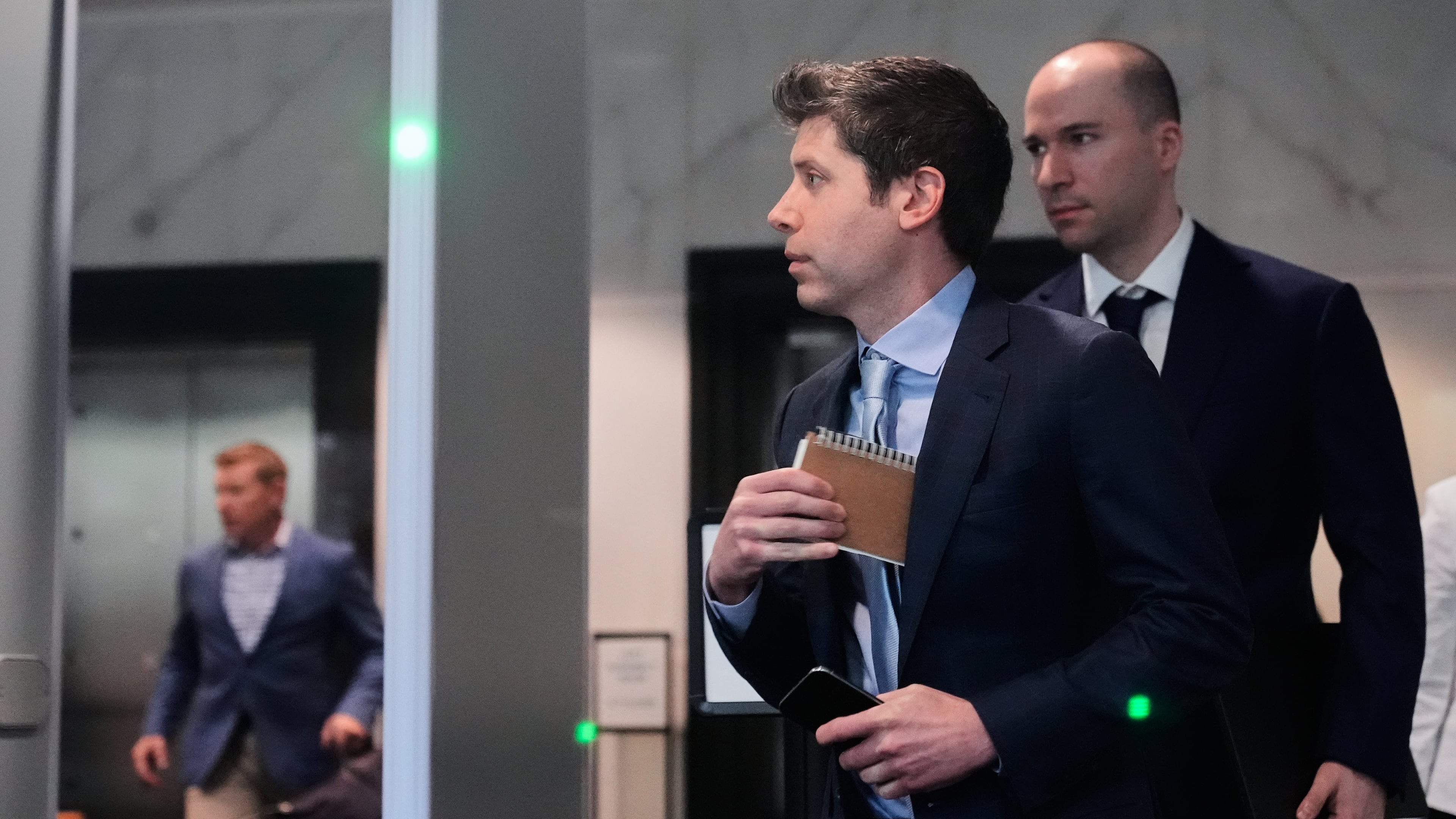 Sam Altman, center, and OpenAI president Greg Brockman, right, arrive at the U.S. District Court in Oakland, Calif., Thursday, April 30, 2026. (AP Photo/Godofredo A. Vásquez)