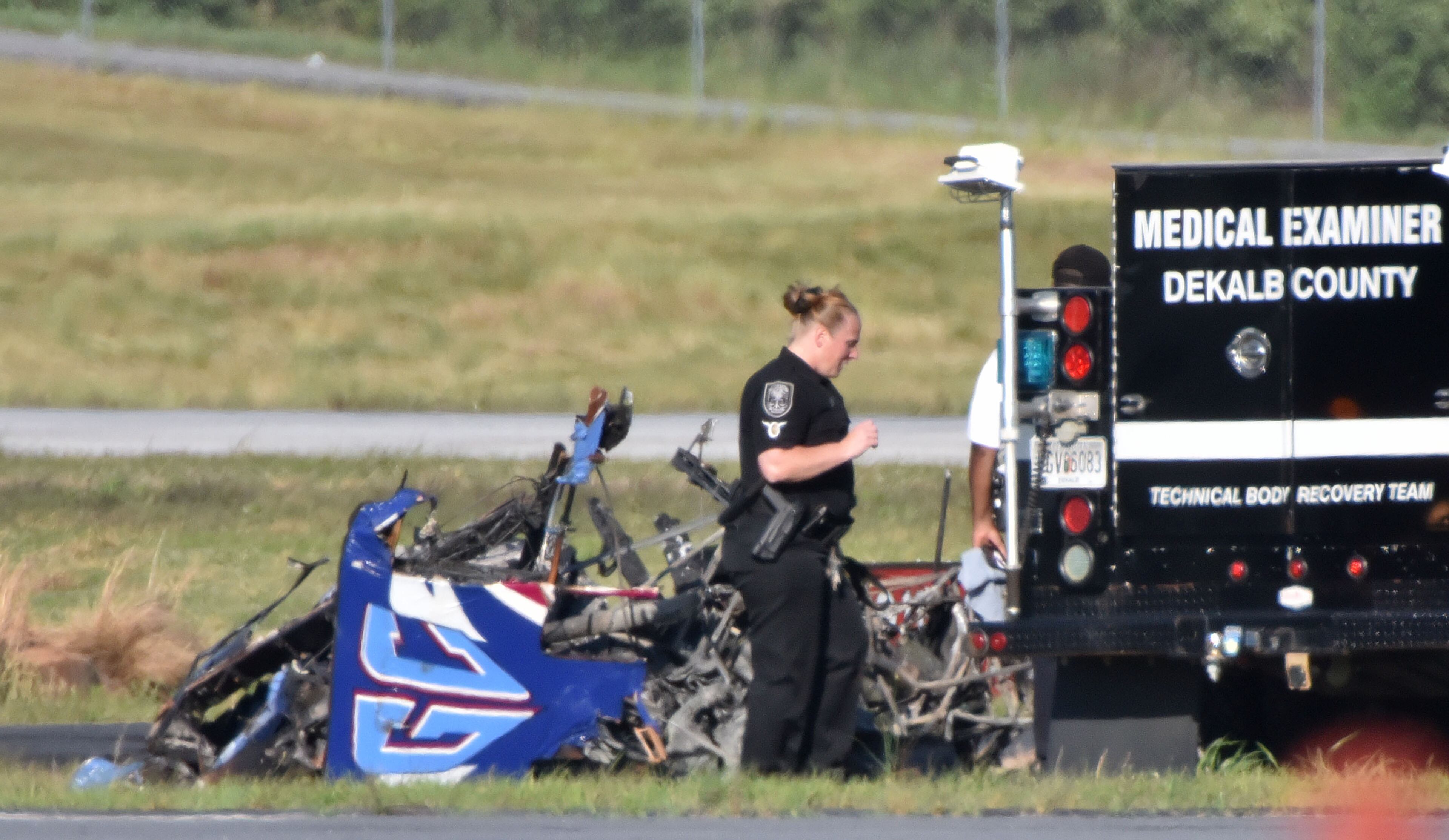 Authorities investigate near the debris of the plane at the crash scene at the Peachtree-DeKalb Airport on Saturday afternoon, May 14, 2016. The pilot of a plane was killed Saturday afternoon when it crashed during an air show at Peachtree-DeKalb Airport, officials said. The crash occurred near the end of the Good Neighbor Day Air Show and Open House at PDK, about 4:49 p.m. The pilot was from the Augusta area, airport director Mario Evans said Saturday at a media briefing. His identity was not released, pending notification of next of kin. HYOSUB SHIN / HSHIN@AJC.COM