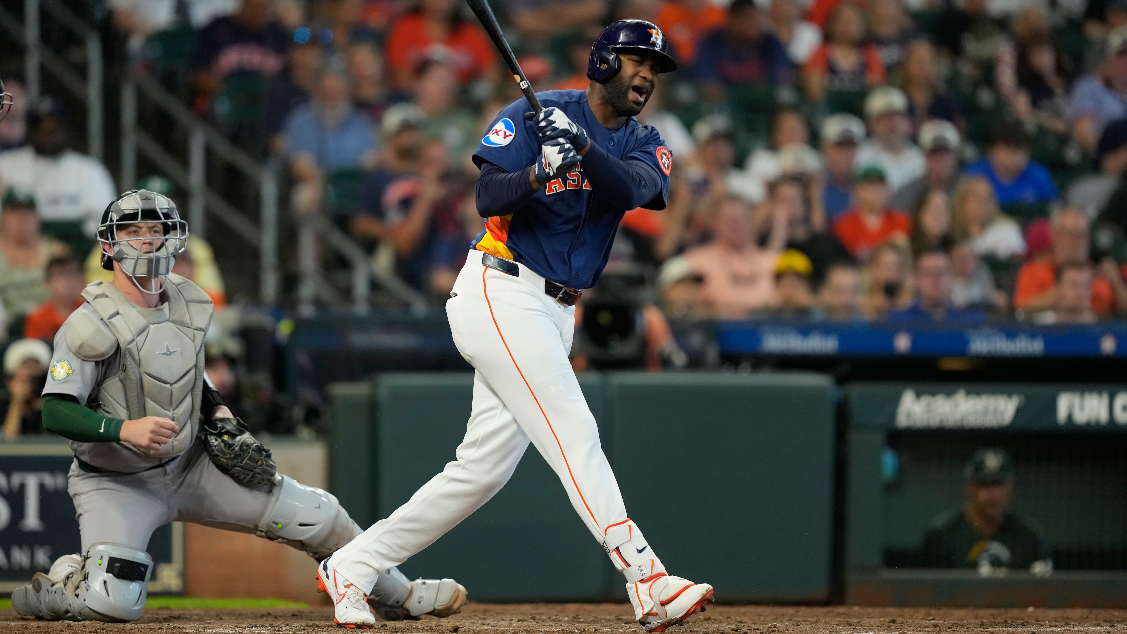 Houston Astros' Yordan Alvarez, right, reacts after fouling a pitch off his foot in front of Athletics catcher Brian Serven during the fourth inning of a baseball game Sunday, Aug. 23, 2026, in Houston. (AP Photo/David J. Phillip)