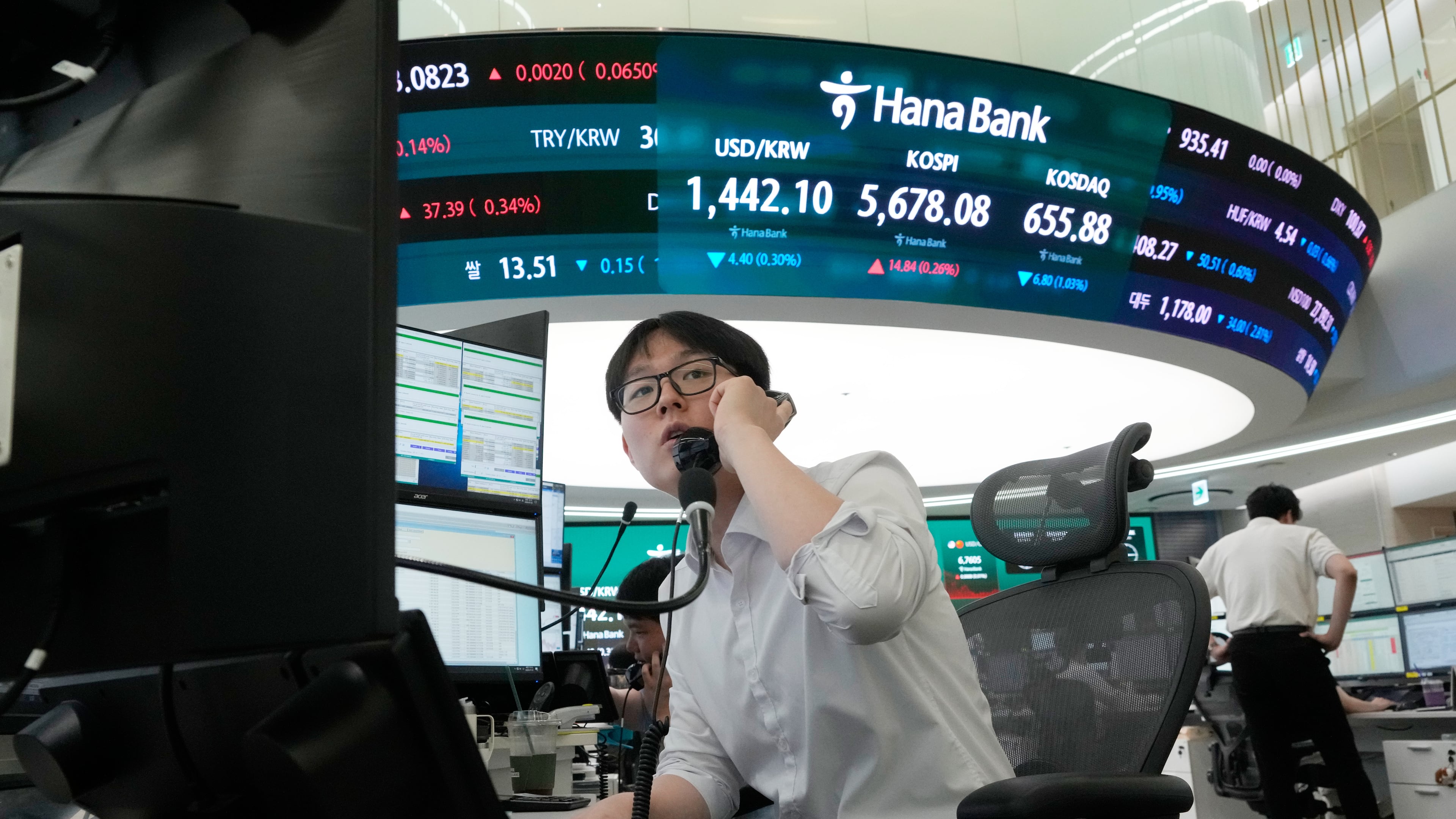 A currency trader talks on the phone at the foreign exchange dealing room of the Hana Bank headquarters in Seoul, South Korea, Thursday, July 30, 2026. (AP Photo/Ahn Young-joon)