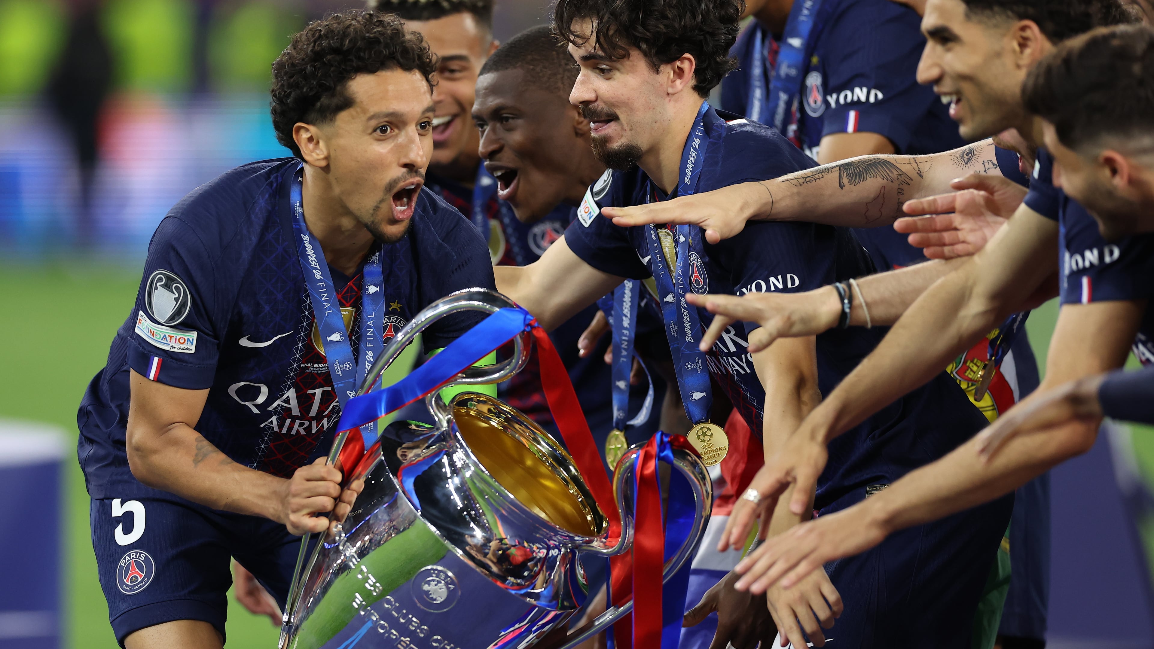 PSG players celebrate with a trophy after the Champions League final soccer match between Paris Saint-Germain and Arsenal in Budapest, Hungary, Saturday, May 30, 2026. AP Photo/Armin Durgut)