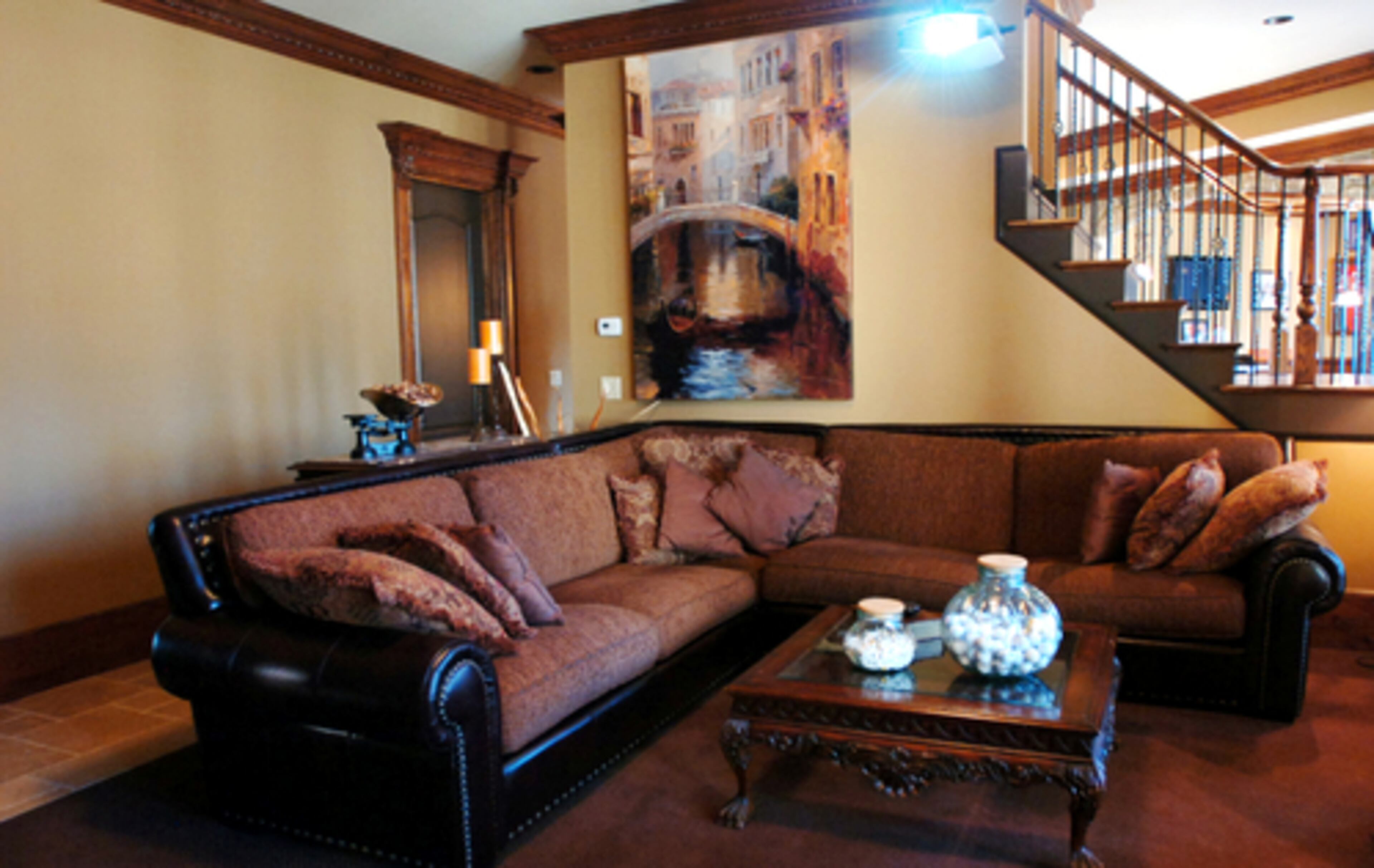 The basement media room includes a 110-inch projection television surrounded by wood trim.