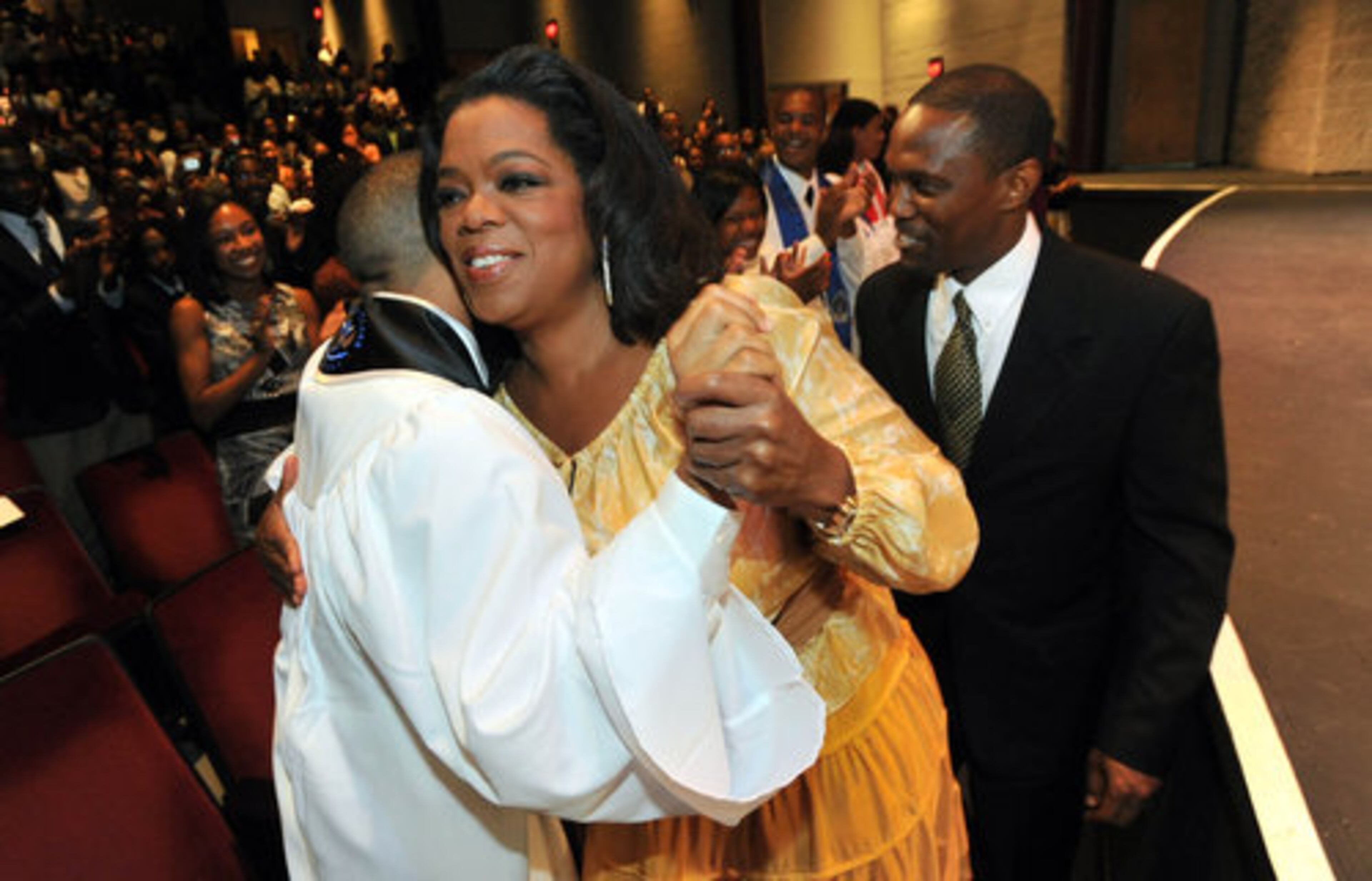 I'M A GIVER: Valedictorian Osei Avril gets a hug from Oprah Winfrey during Ron Clark Academy's inaugural graduation ceremony at the Ferst Center for the Arts at Georgia Tech. The talk-show host and media mogul has donated nearly $2 million to the private school since it opened three years ago.