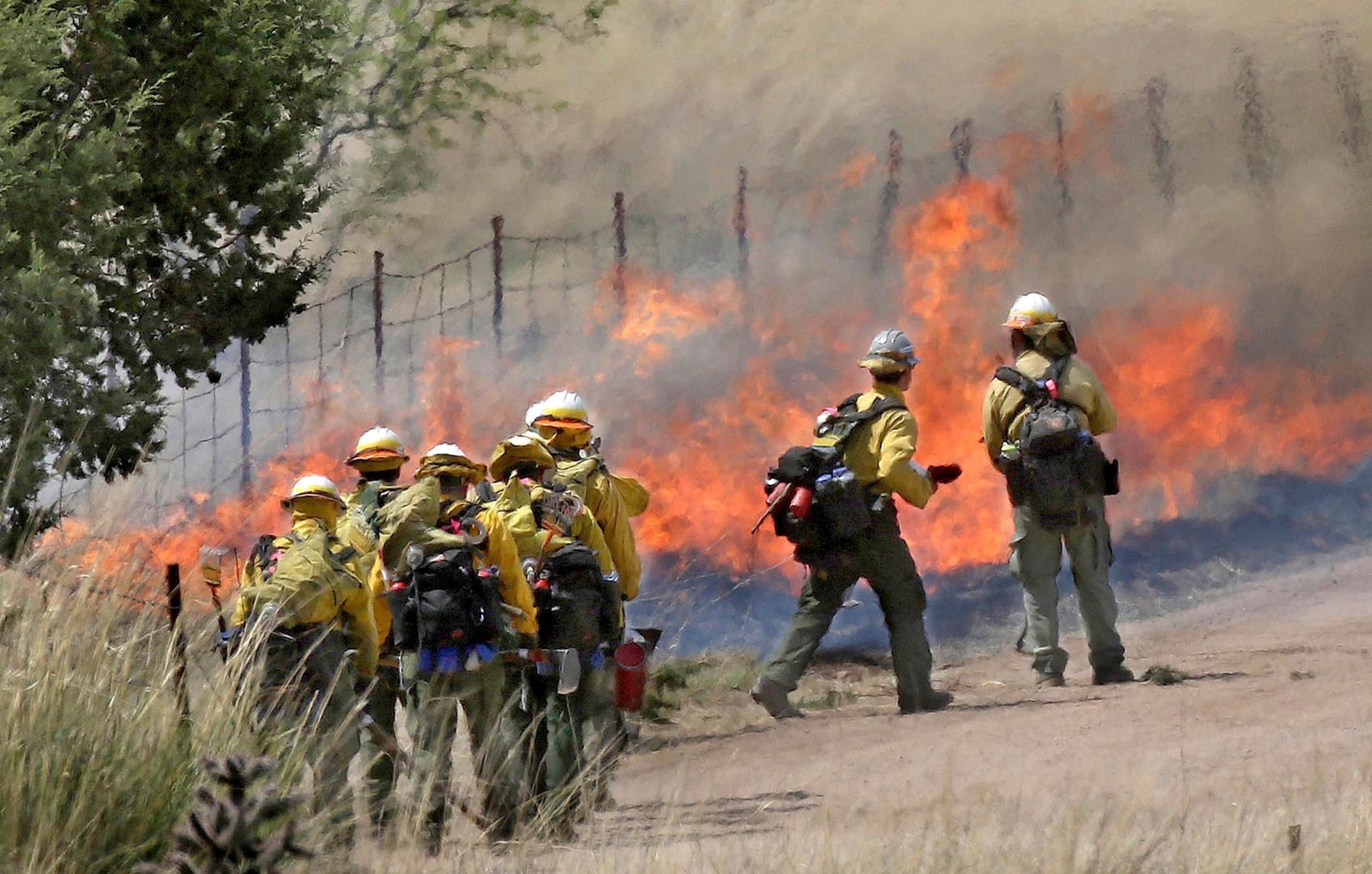 Fire crews monitor a defensive fire line east of the main Sawmill Fire along Box Canyon and East Greaterville Roads north of Sonoita, Ariz., on April 24, 2017. The fire began Sunday near Madera Canyon in the Santa Rita Mountains south of Tucson and by Monday had raced eastward and ballooned to 7,000 acres. Pre-evacuation orders have been issued. Heavy air tankers and helicopters have been used to slow the fire. (A.E. Araiza/Arizona Daily Star via AP)