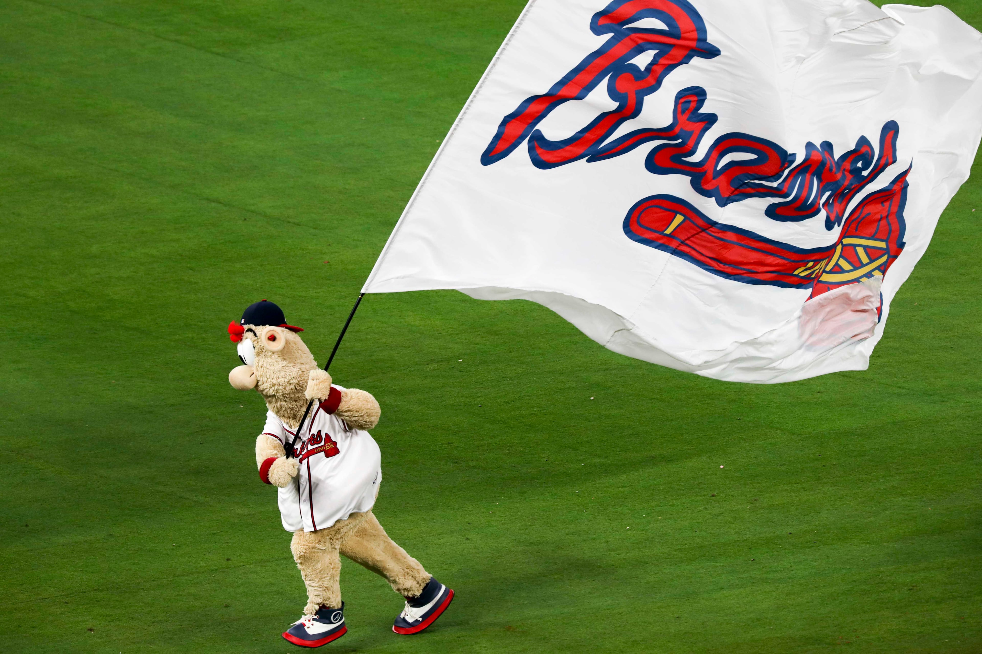 03/29/2018 -- Atlanta, GA - Braves mascot Blooper runs the team flag across the field after the Braves beat the Phillies during the season opener game at SunTrust Park, Thursday, March 29, 2018. The Braves beat the Phillies, 8-5. ALYSSA POINTER/ALYSSA.POINTER@AJC.COM